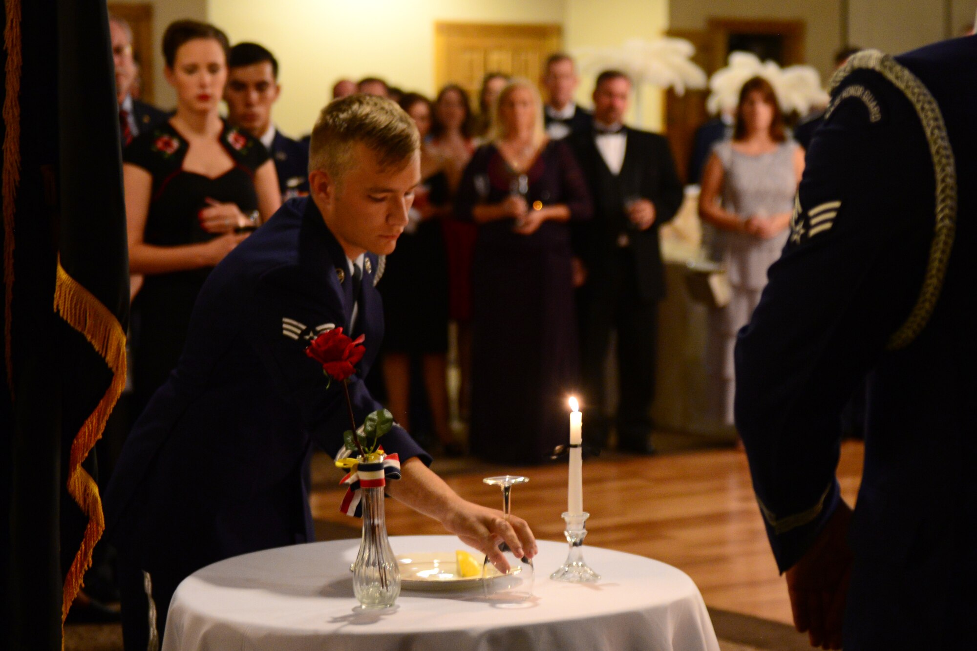 Guests gather to honor Prisoner-of-War/Missing-in-Action and fallen warriors during an honor guard ceremony at the Air Force Ball, Sept. 20, 2014, at the Landing Zone at Cannon Air Force Base, N.M. The annual ball takes place to honor the anniversary of the National Security Act of 1947, which made the Air Force an independent branch of the military upon its passage on Sept. 18, 1947. (U.S. Air Force Photo/Airman 1st Class Shelby Kay-Fantozzi)
