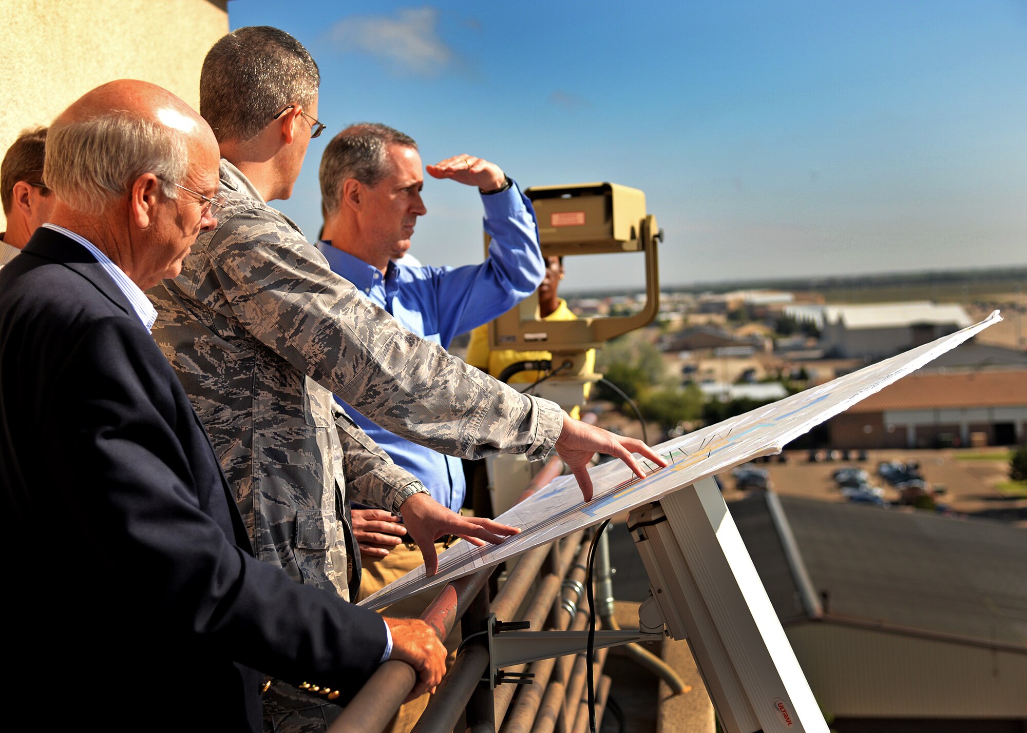 U.S. Air Force Lt. Col. Joel Sloan, 27th Special Operations Civil Engineer Squadron commander, gives Reps. Mac Thornberry, House Armed Services Committee vice chairman, and Steve Pearce, House Financial Services member, a tour of plans and initiatives to improve base functions and quality of life Sept. 25, 2014 at Cannon Air Force Base, N.M. Sloan emphasized the projects that are taking place in the future to continue growing Cannon as a premier Air Force installation. (U.S. Air Force photo/Airman 1st Class Chip Slack)