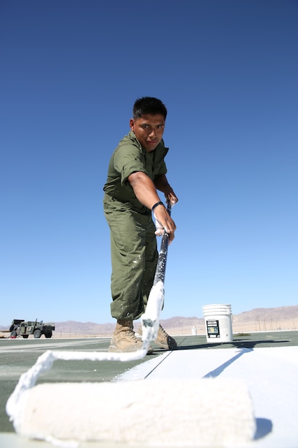 Sgt. Horacio Leyva, runway supervisor, Marine Wing Support Squadron 374, paints the number at the approach section of the Strategic Expeditionary Landing Field, Camp Wilson, Sept. 29, 2014. The section was replaced to make the approach safer for aircraft that land at Camp Wilson.