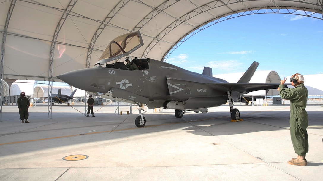 Marines with Marine Fighter Attack Squadron (VMFA) 121 “Green Knights,” conduct a maintenance check on an F-35B Lightning II on the flight line aboard Marine Corps Air Station Yuma, Arizona, Aug. 18, 2014.
