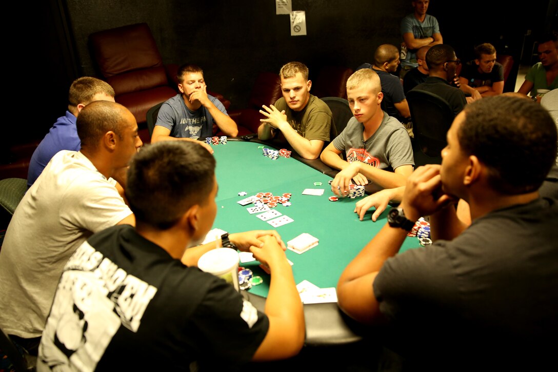 Marines play a hand of Texas Hold’em at The 5th Street Zone, Sept. 26. The Zone holds a Texas Hold’em tournament on the last Friday of every month and has been holding the tournament for four years.