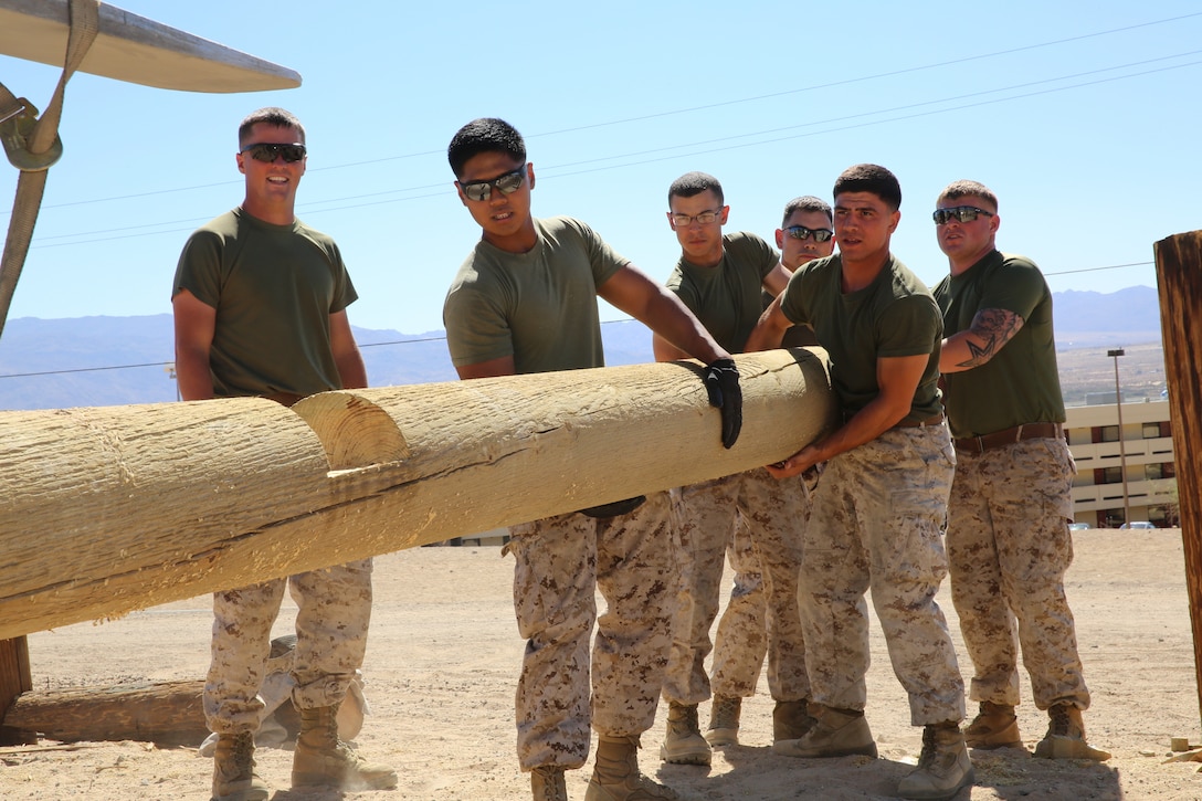 Marines with Combat Logistics Battalion 7 work together to lift a log during the renovation of an obstacle course aboard Twentynine Palms, California Sept. 29, 2014.