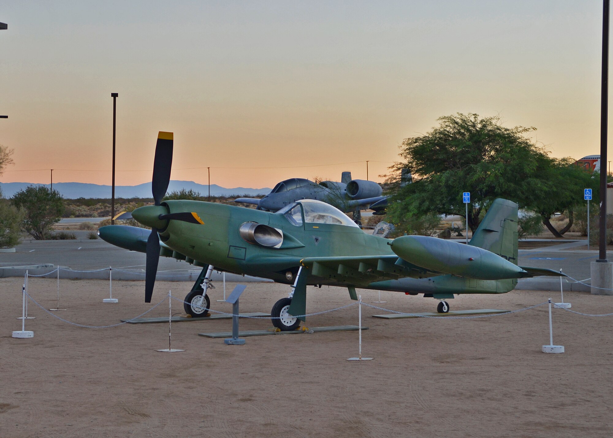 A Piper PA-48 Enforcer now sits at the Air Force Flight Test Museum since Sept. 22. The AFFT Museum recently acquired two remodeled historic aircraft, a YF-4E Phantom II and a Piper PA-48 Enforcer, during the end of September to add to its lineup of historic flight test aircraft. The Piper PA-48 Enforcer is a turboprop powered light close air support/ground-attack aircraft built by Piper Aircraft Corp. Lakeland, Fla. It was the ultimate development of the original World War II North American P-51 Mustang. The Enforcer concept was originally created and flown by David Lindsay, owner of Cavalier Aircraft, in response to the United States Air Force PAVE COIN program and later sold to Piper by Lindsay in 1970.
In 1968, Cavalier Aircraft owner/founder David Lindsay had begun developing a highly modified version of the Cavalier Mustang for use as a counter-insurgency aircraft. Cavalier initially mated a Rolls-Royce Dart 510 turboprop to a Mustang II airframe, but despite numerous sales attempts to the United States Air Force, neither the U.S. military nor any foreign operators purchased the Turbo Mustang III.
Seeking a company with mass production capability, the Turbo Mustang III, renamed the "Enforcer," was sold to Piper Aircraft in late 1970. In 1984 with a $12 million appropriation from Congress, Piper built two new Enforcers, giving the new prototypes the designation PA-48. These aircraft were evaluated by the USAF, but flown only by Piper test pilots. Since the Enforcer was never in the Air Force inventory, it was not given an official military designation and did not receive an air force serial number. Instead, these aircraft carried the Piper designation PA-48 and FAA registration numbers, N481PE and N482PE.
The two PA-48s were tested during 1983 and 1984 at Eglin Air Force Base, Fla., and Edwards Air Force Base, Calif. As in the Pave COIN tests of 1971, the PA-48s were found to perform well in their intended role, but the USAF decided not to purchase the aircr