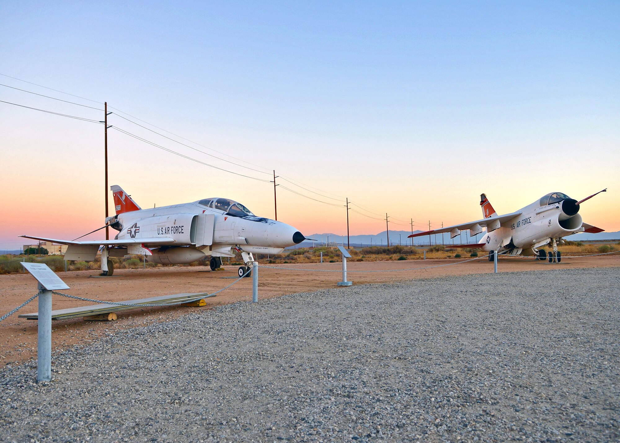 A YF-4E Phantom II (left) can be seen next to a Vought A-7 Corsair II at the Air Force Flight Test Museum Sept. 23. The AFFT Museum recently acquired two remodeled historic aircraft, a YF-4E Phantom II and a Piper PA-48 Enforcer, during the end of September to add to its lineup of historic flight test aircraft. 
The YF-4E Phantom II is one of three prototypes built to test and evaluate the internally mounted M-61 Vulcan rotary cannon. The prototype was produced by modifying an existing F-4D to accept both the new nose mounted weapon and a smaller solid-state Westinghouse AN/APQ-120 X-band radar set. This aircraft was the first to fly with both the new gun and radar onboard and helped to usher in one of the most lethal variants of a legendary warplane. To find out more information about the Air Force Flight Test Museum, contact George Welsh at (661) 277-8050. (U.S. Air Force photo by Jet Fabara)