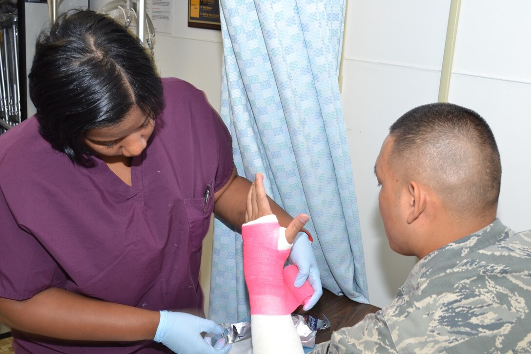 Staff Sgt. Nandie-Boy Merjilla, 779th Medical Group staff member, is having his hand casted by Mrs. Carla Bond from the 779th Medical Group Orthopedics Clinic. (Air Force Photo by Master Sgt. Aimee Klarmann)
