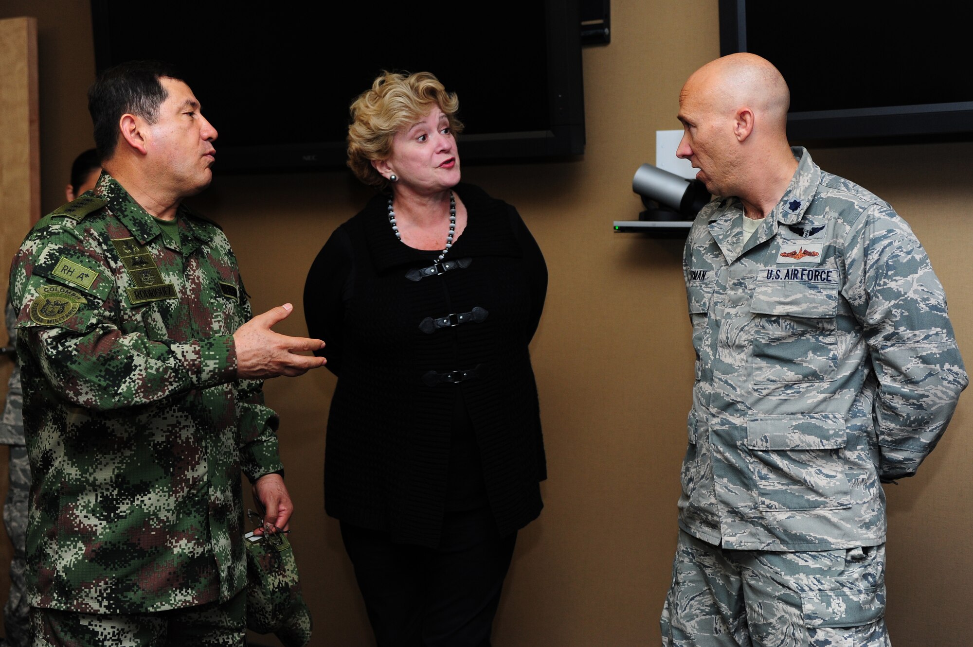 U.S. Air Force Lt. Col Cameron Thurman, 480th Intelligence, Surveillance and Reconnaissance Wing surgeon, briefs Colombian Gen. Juan Pablo Rodriguez, Armed Forces, Colombia commander, through his translator on the importance of a resiliency team within the 480th ISRW at Langley Air Force Base, Va., Sept. 26, 2014. In addition to a surgeon, the team is also compromised of a psychologist and a chaplain who promote the Comprehensive Airman Fitness campaign throughout the wing. (U.S. Air Force Photo by Airman 1st Class Areca T. Wilson/Released) 