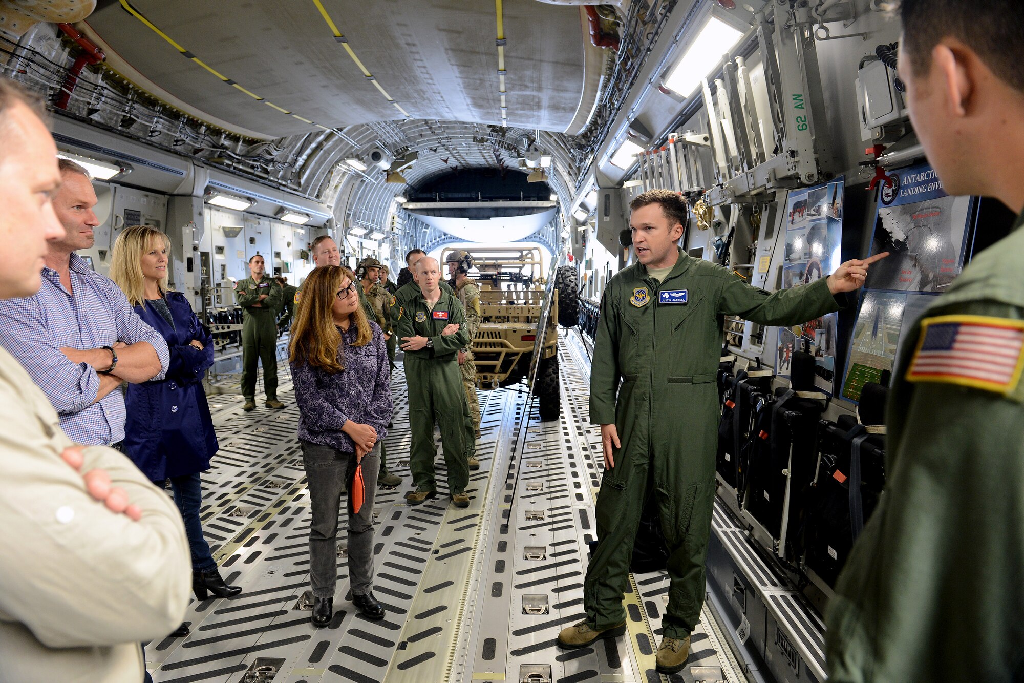 Capt. Justin Jarrel (right), 7th Airlift Squadron pilot, explains McChord Field’s role in  Operation Deep Freeze in Antarctica to representatives from Disney’s Apprenticeship Program Sept. 29, 2014, during their tour at Joint Base Lewis-McChord, Wash. During the tour, the representatives learned about the various types of missions the C-17 Globemaster III flies such as medical evacuations, precision airdrops, cargo, and passenger transportation movements. (U.S. Air Force photo/Airman 1st Class Keoni Chavarria)