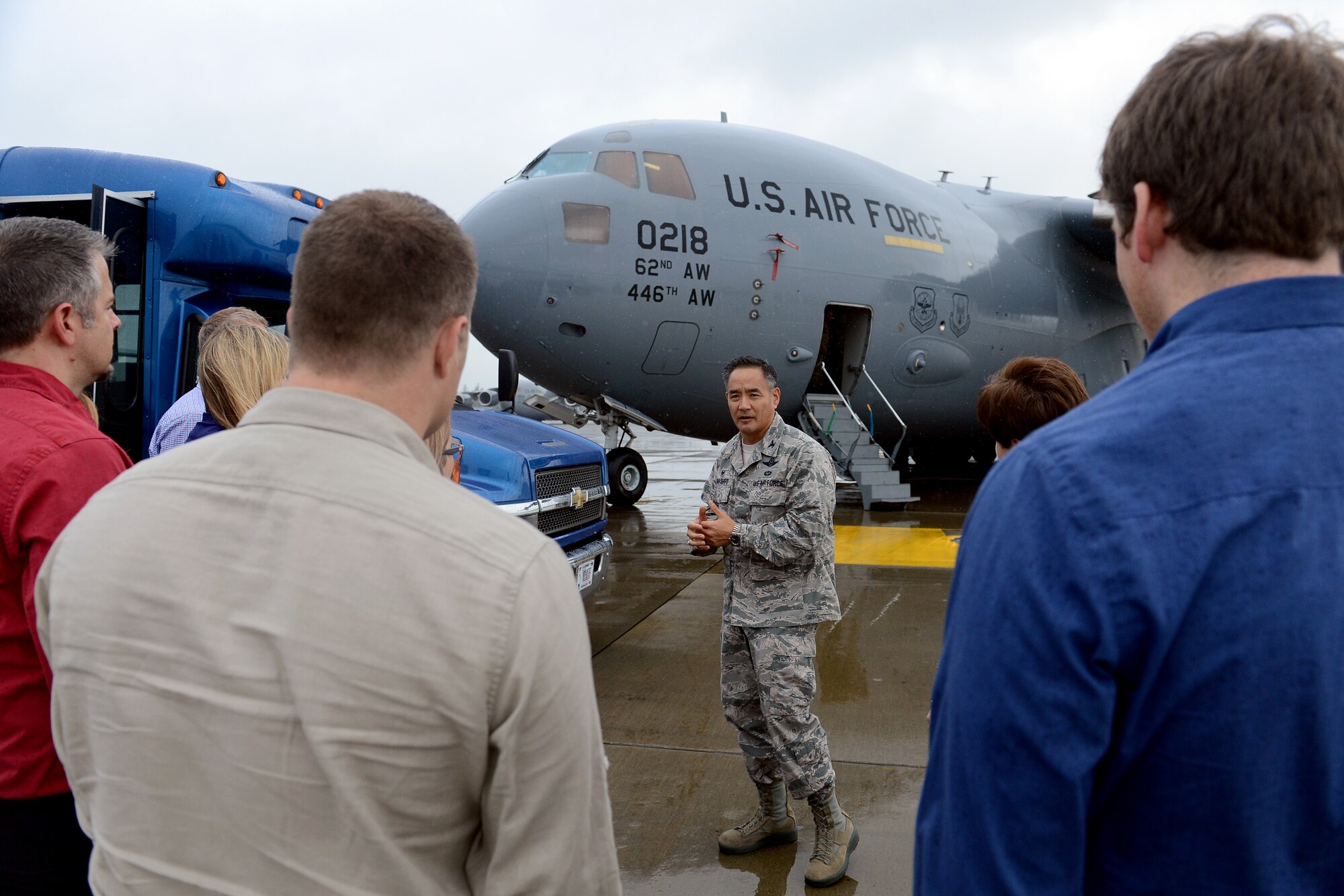 Col. David Kumashiro, 62nd Airlift Wing commander, briefs representatives from Disney’s Apprenticeship Program about a C-17 Globemaster III prior to boarding the aircraft for their tour Sept. 29, 2014, at Joint Base Lewis-McChord, Wash. The visitors were able to meet McChord Airmen from the 22nd Special Tactics Squadron, 62nd Operations Support Squadron, 4th Airlift Squadron, and the 7th Airlift Squadron and learn about their jobs. (U.S. Air Force photo/Airman 1st Class Keoni Chavarria)