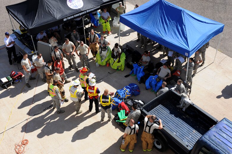 Darren Felish, 355th Civil Engineer Squadron Fire and Emergency Services station chief, briefs hazardous material responders on safety and incident objectives prior to entering a simulated contaminated area at Davis-Monthan Air Force Base, Ariz., Sept. 29, 2014. The purpose of this training is to exercise the cohesiveness among emergency responders. Responders were affiliated with several agencies to include Fire Protection, Emergency Management, Bioenvironmental Engineering, and Explosive Ordnance Disposal.  (U.S. Air Force photo by Airman 1st Class Cheyenne Morigeau/Released) 