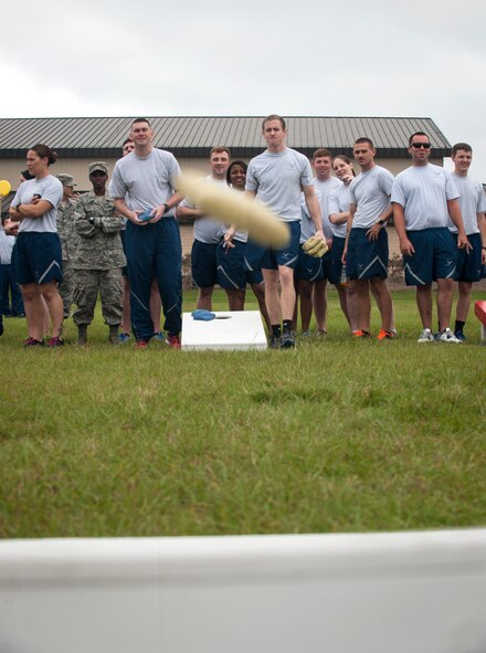 David Wolff, front right, 23d Comptroller Squadron, watches as his bag flies to the target during a cornhole game Sept. 30, 2014, at Moody Air Force Base, Ga. Cornhole was one of 12 events held during Super Sports Day. (U.S. Air Force photo by Senior Airman Jarrod Grammel/Released)
