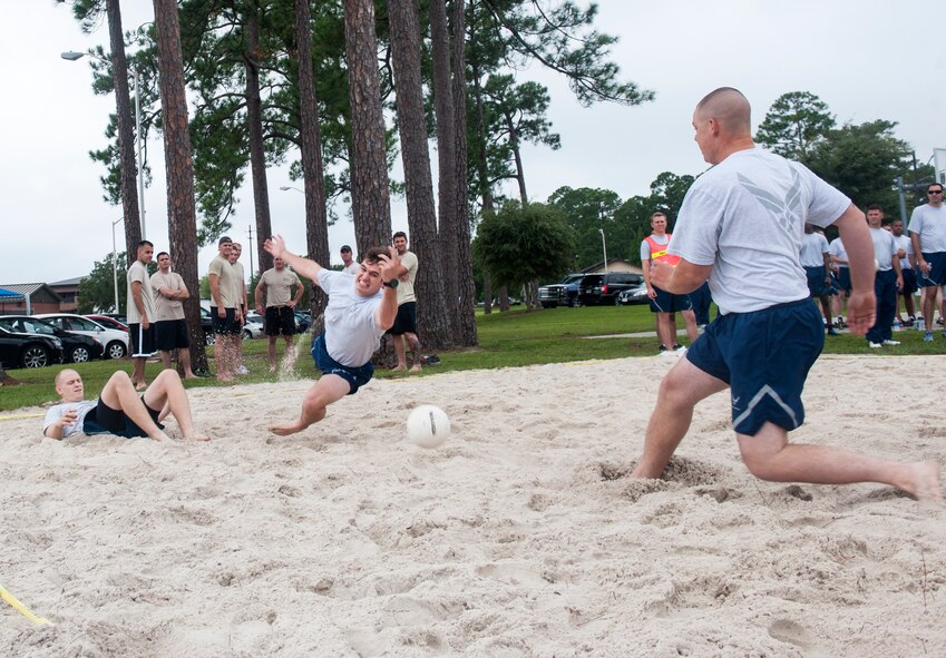 Players scramble for the ball during a Super Sports Day volleyball game Sept. 30, 2014, at Moody Air Force Base, Ga. A total of 17 teams competed in the volleyball tournament. (U.S. Air Force photo by Senior Airman Jarrod Grammel/Released)
