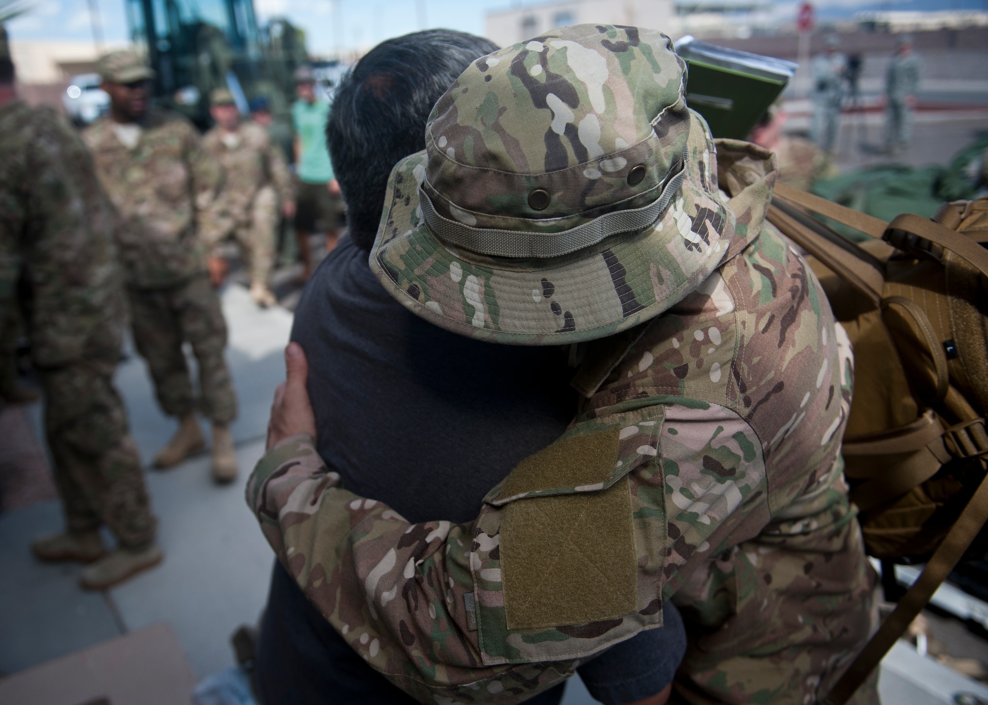 An Airman embraces and thanks a coworker before leaving for a deployment to Southwest Asia at Nellis Air Force Base, Nev., Sept 26, 2014. Airmen from the 58th Rescue Squadron, 66th Rescue Squadron, 823rd Maintenance Squadron, and Det. 1, 563rd Operations Support Squadron are deploying to support Operation Enduring Freedom. (U.S. Air Force photo by Staff Sgt. Siuta B. Ika)