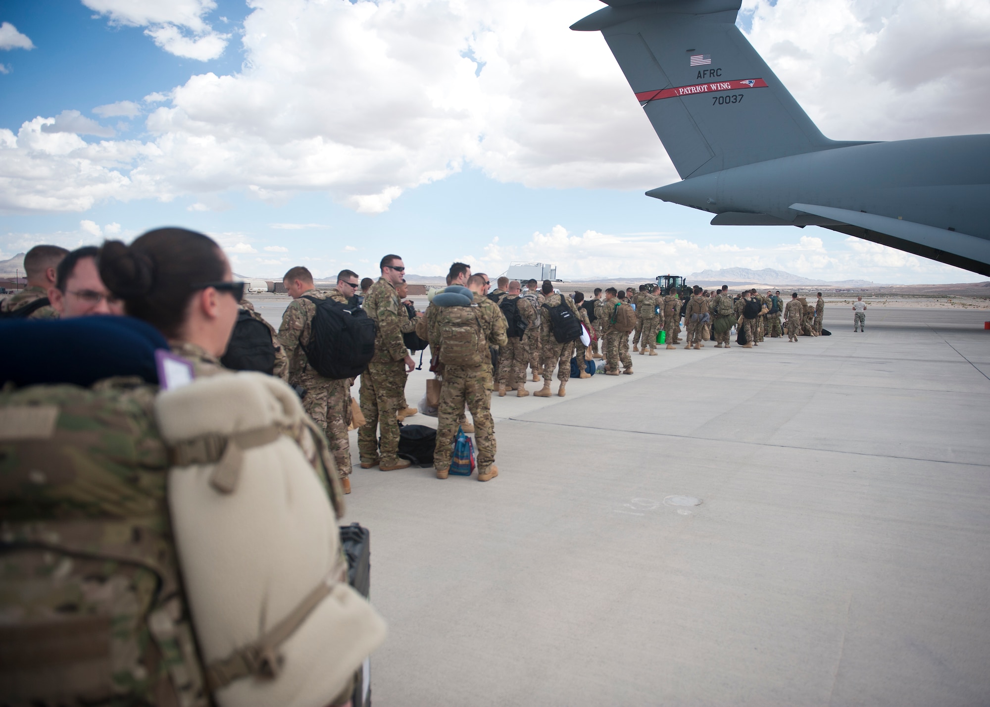 Airmen from the 58th Rescue Squadron, 66th Rescue Squadron and 823rd Maintenance Squadron prepare to board a C-5 Galaxy from the 439th Airlift Wing, Westover Air Reserve Base, Mass., at Nellis Air Force Base, Nev., Sept. 26, 2014. The Airmen are deploying to Southwest Asia in support of Operation Enduring Freedom. (U.S. Air Force photo by Staff Sgt. Siuta B. Ika)