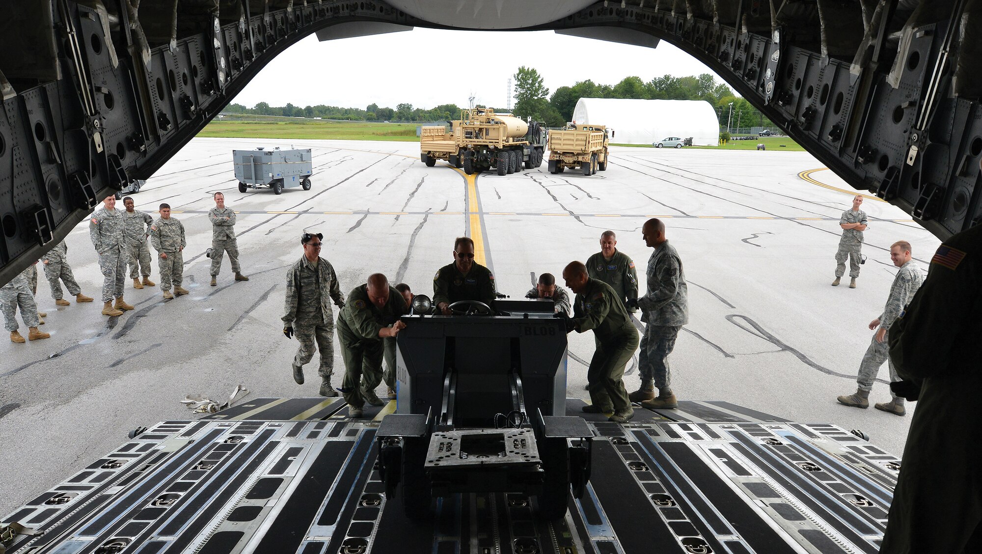 TOLEDO, Ohio - Large and small items were the subject of loading on a 445th Airlift Wing C-17 Globemaster III at the Toledo Express Airport Sept. 6, 2014. Sixteen loadmasters from the 89th Airlift Squadron were training Army Reserve and Air National Guard members on the art of loading the transport aircraft. The unique loads included two five tons trucks, a mobile command center. (U.S. Air Force photo/Tech. Sgt. Frank Oliver)