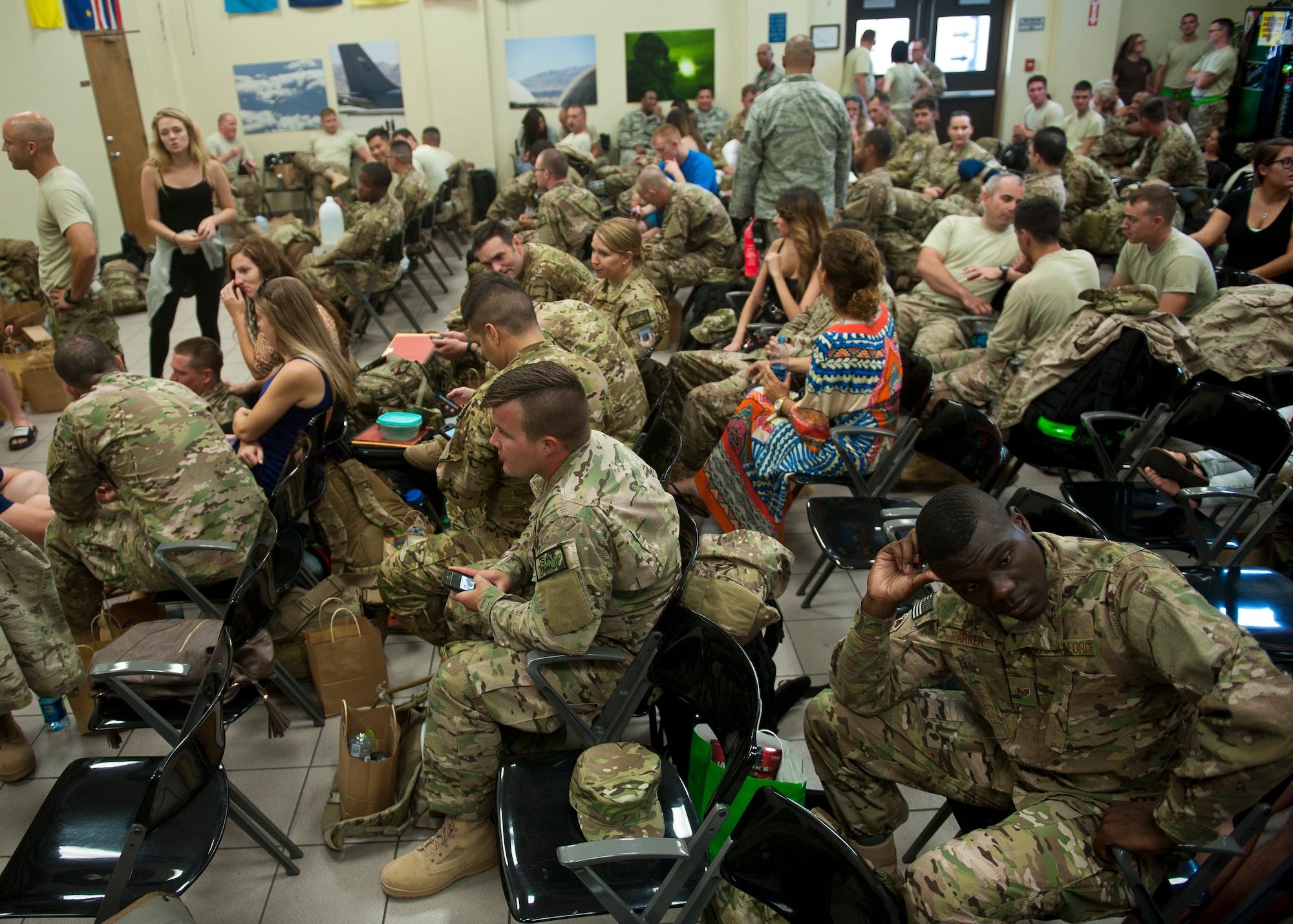 Airmen from the 58th Rescue Squadron, 66th Rescue Squadron and 823rd Maintenance Squadron wait with their families before deploying to Southwest Asia in the air terminal at Nellis Air Force Base, Nev., Sept. 26, 2014.  Many of these Airmen are deploying for the first time in their careers. (U.S. Air Force photo by Staff Sgt. Siuta B. Ika)