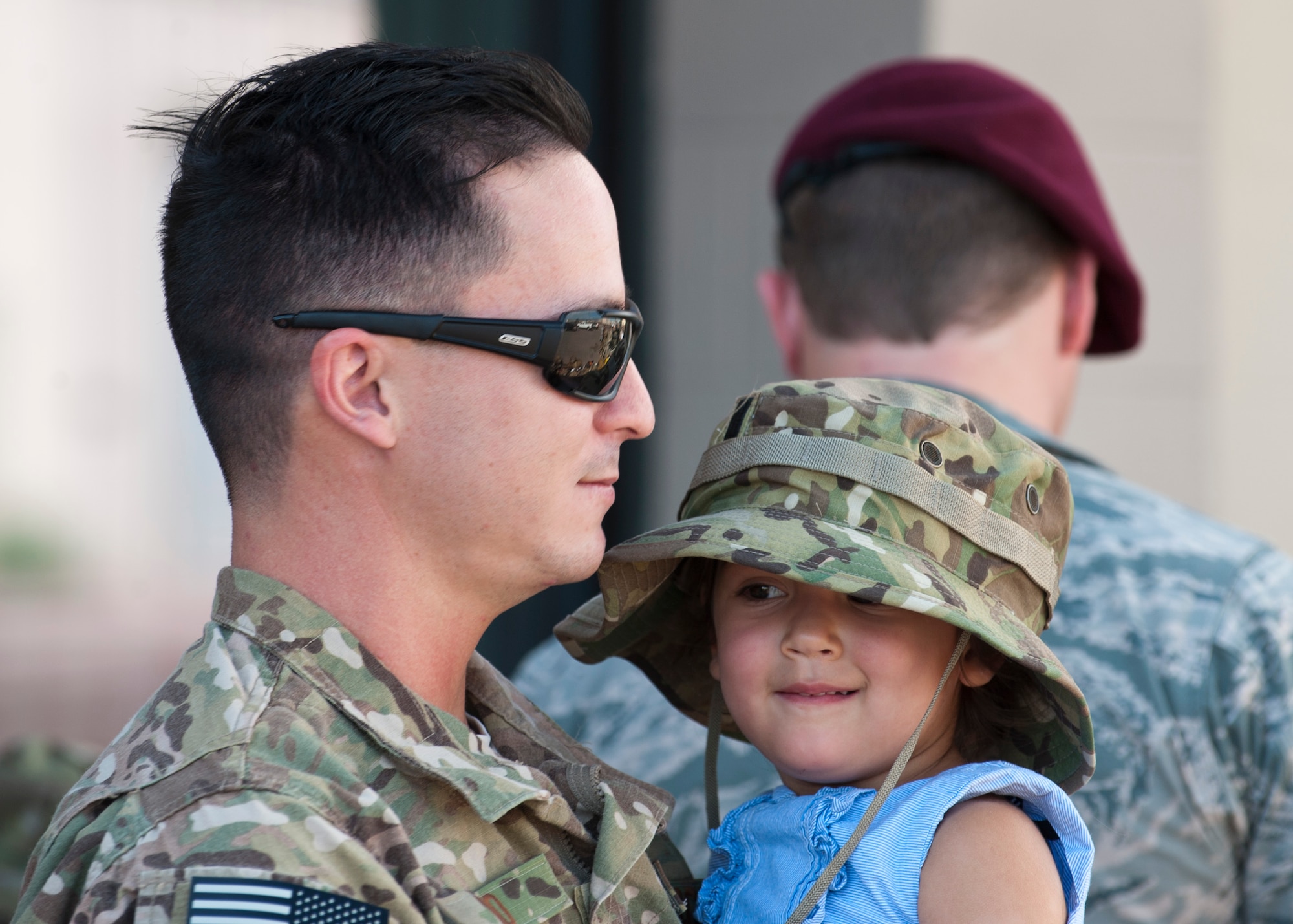 1st Lt. Christopher Ino, 58th Rescue Squadron combat rescue officer, holds his daughter before going on a deployment at Nellis Air Force Base, Nev., Sept. 26, 2014. Ino, along with other Airmen from the 58th RQS, 66th RQS, 823rd Maintenance Squadron, and Det. 1, 563rd Operations Support Squadron, are deploying to Southwest Asia in support of Operation Enduring Freedom. (U.S. Air Force photo by Airman 1st Class Thomas Spangler)