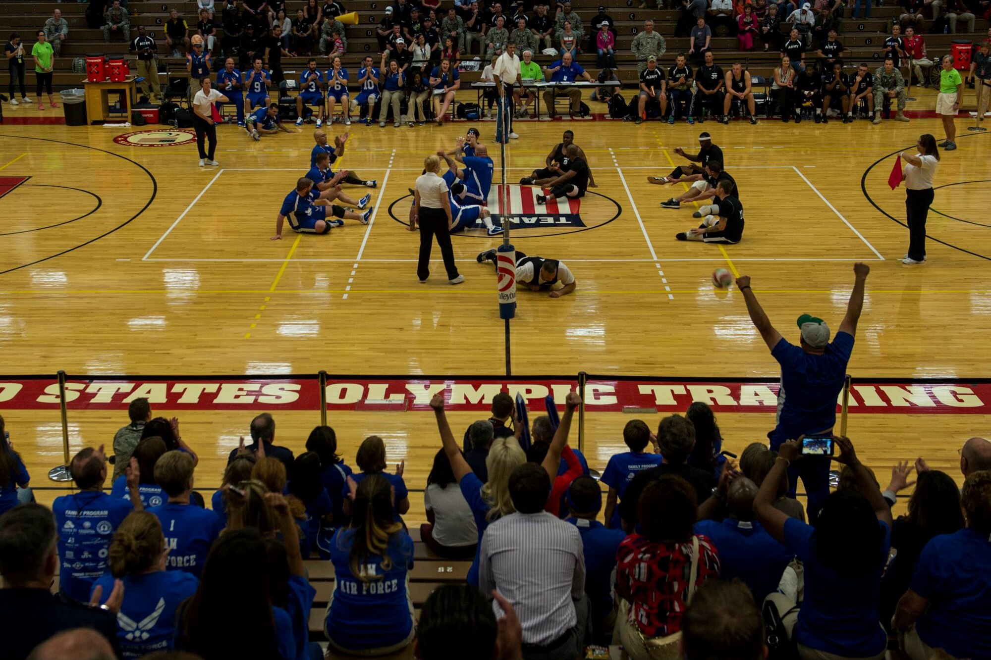 Fans of the U.S. Air Force sitting volleyball team celebrate a point during the opening day of the Wounded Warrior Games September 28, 2014 at the Olympic Training Center in Colorado Springs, Colorado. The 2014 Warrior Games features wounded athletes from throughout the Department of Defense who compete in Olympic style events for their respective military branch. The goal of the games is to help highlight the limitless potential of warriors through competitive sports. (U.S. Air Force photo by Airman 1st Class Taylor Queen)

