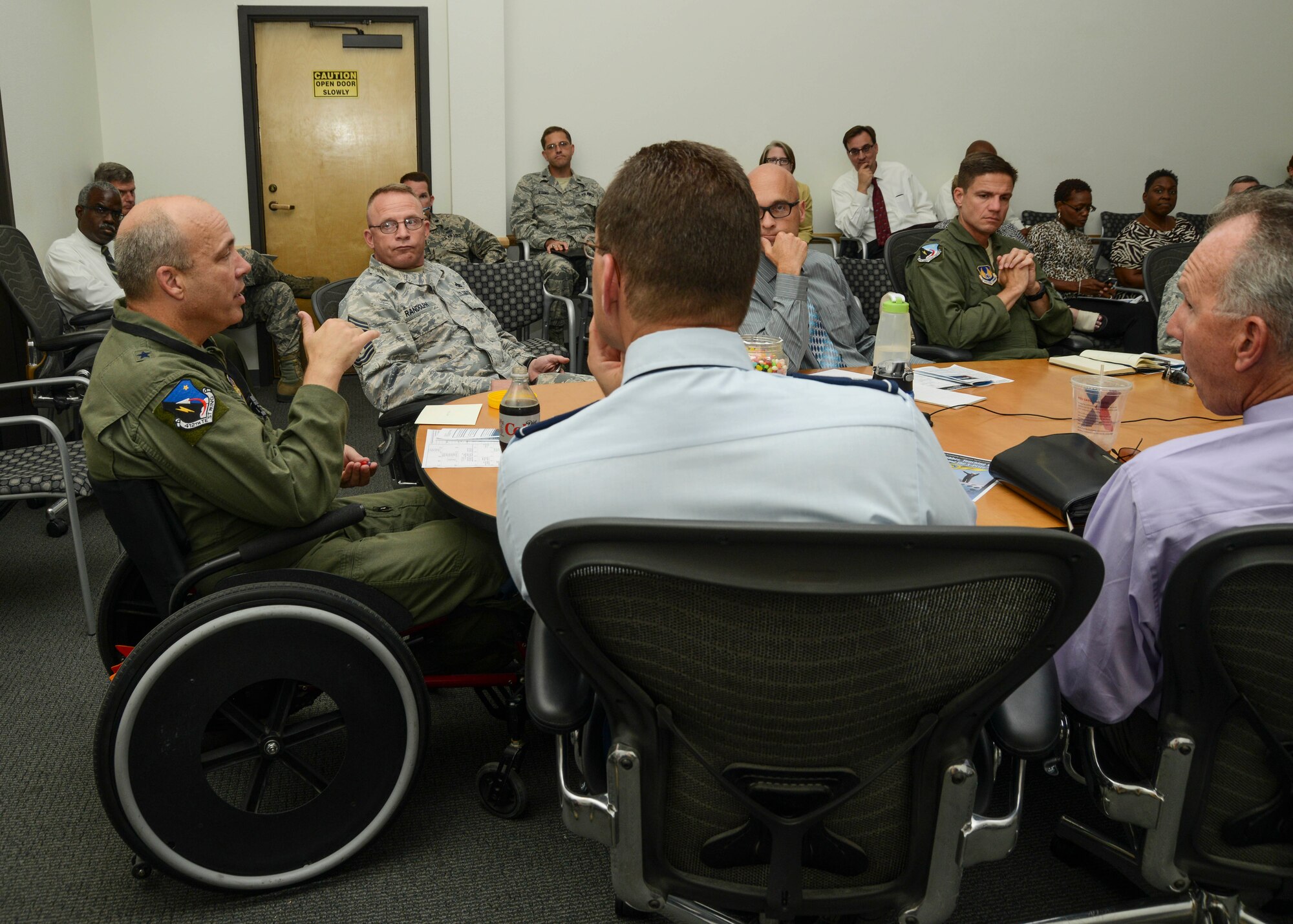 Brewer attended the entire weekly staff meeting situated in a wheelchair for National Disability Employment Awareness Month, which is held every October across the U.S.(U.S. Air Force photo by Rebecca Amber)