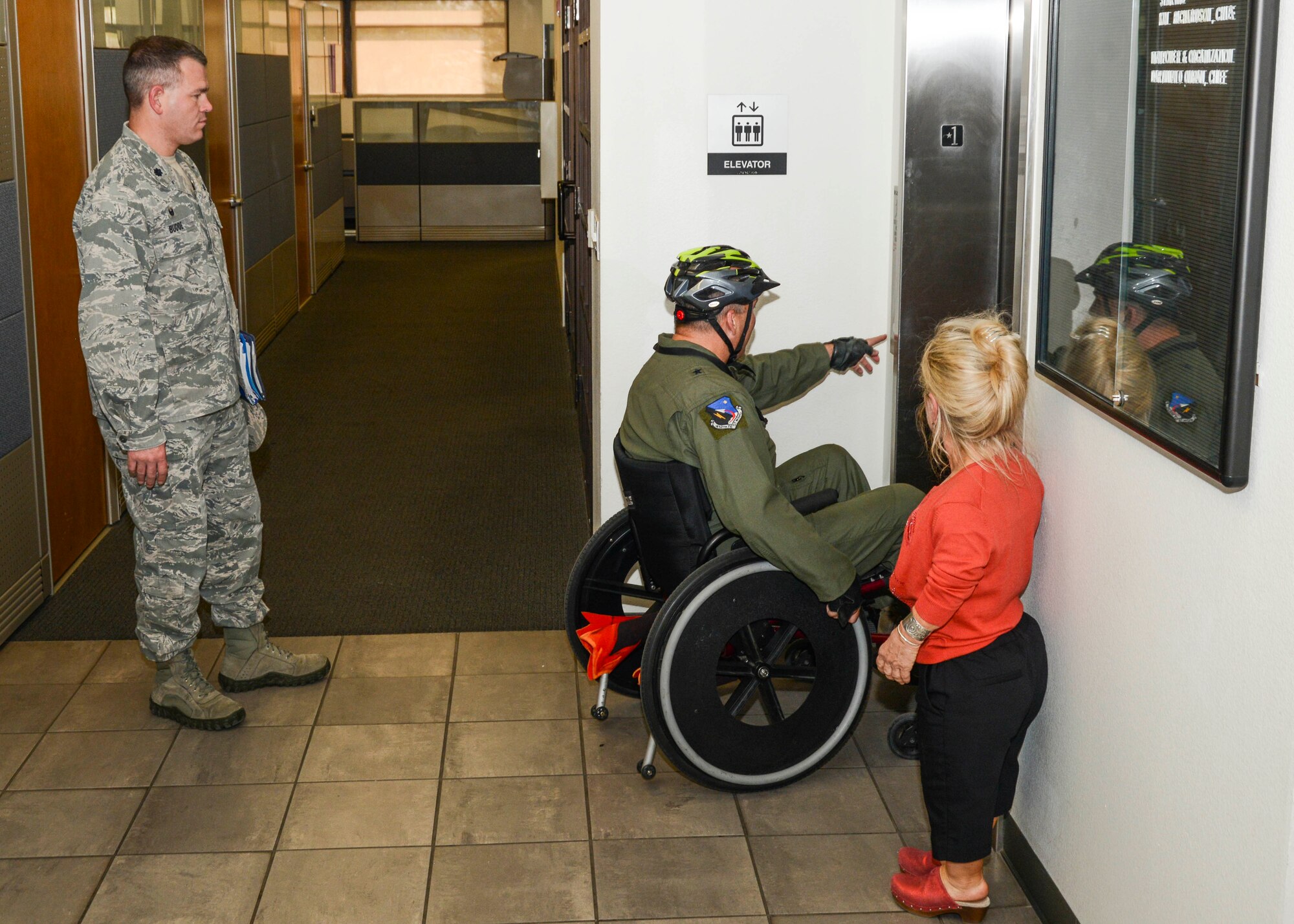 Lt. Col. Christopher Budde (far left), 412th Communications Squadron commander, watches as Brig. Gen. Michael T. Brewer, 412th Test Wing commander, attempts to enter an elevator in Bldg. 3000 to attend the weekly Test Wing Staff Meeting on the second floor in the Justin Room. (U.S. Air Force photo by Rebecca Amber)