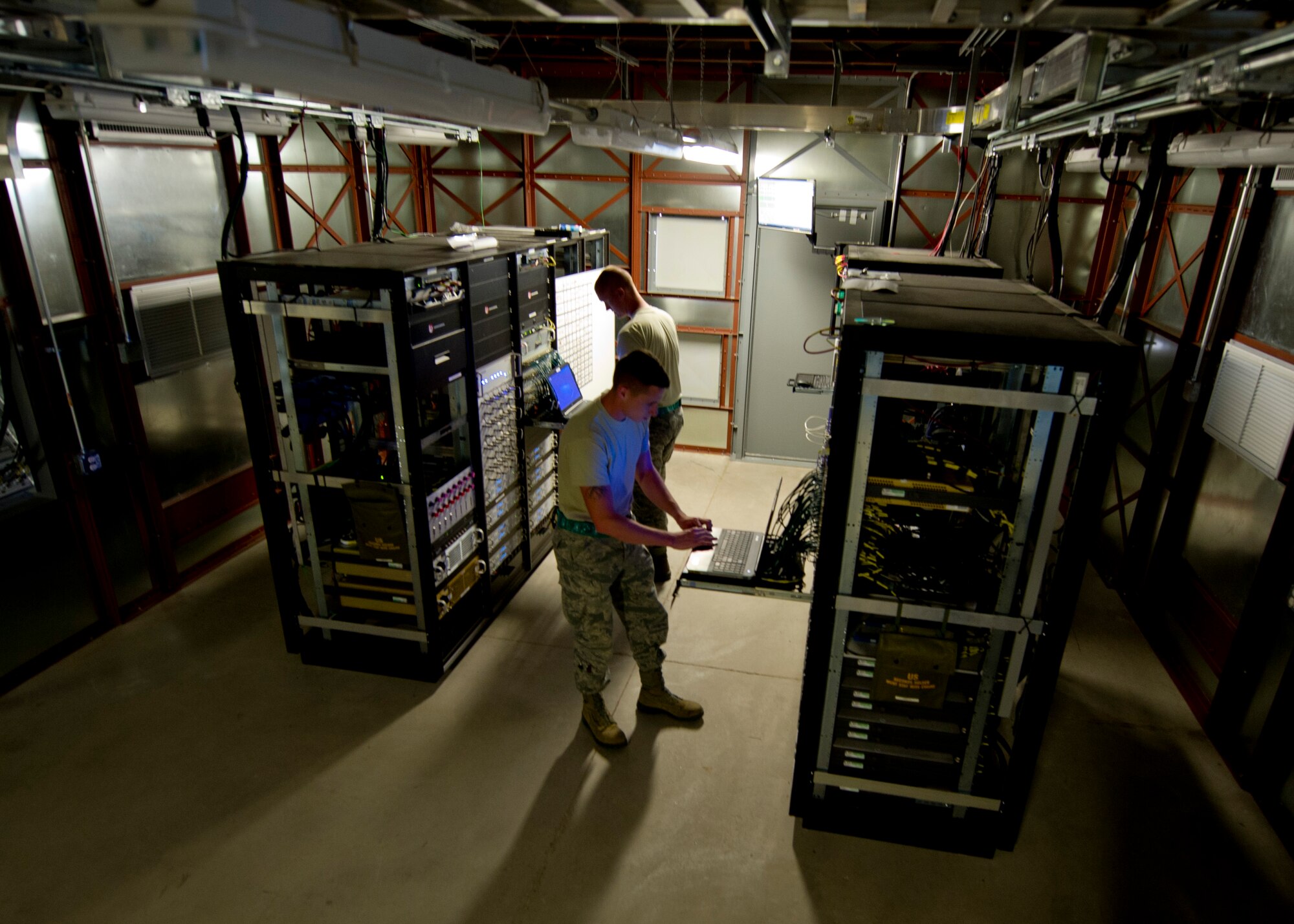 Airman 1st Class Tyler Christian, 49th Communications Squadron ground control station establishes a satellite connection for Remotely Piloted Aircraft at Holloman Air Force Base, N.M., 25 Sept. As a ground control station maintainer, one of the key aspects of Christian’s job is establishing a clean connection to the satellites that allow the pilots to remotely pilot aircraft from thousands of miles away. Holloman AFB is home to the primary training facilities for all RPA pilots and sensor operators in the Air Force, the program is responsible for preparing the flight crews for real-world combat missions down the road. (U.S. Air Force photo by Senior Airman Daniel E.F. Liddicoet/Released)