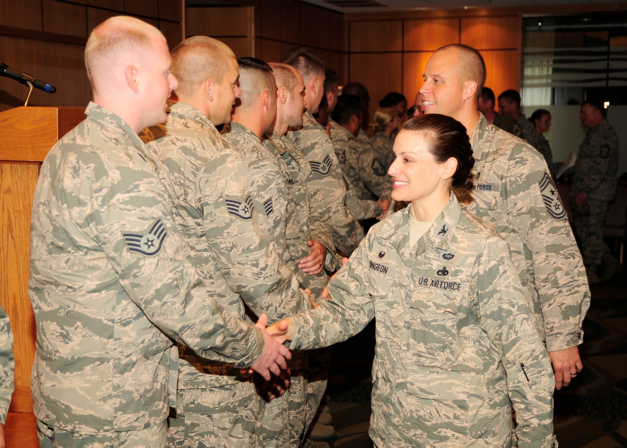 Colonel Jacqueline Mongeon, 325th Maintenance Group commander and Chief Master Sgt. Christopher Lantagne, 325th Fighter Wing Command Chief, shake Team Tyndall promotees’ hands after the October promotions ceremony Sept. 30 at the Horizons Community Center. (U.S. Air Force photo by Airman 1st Class Solomon Cook)