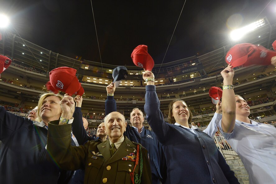 Secretary of the Air Force Deborah Lee James and Air Force Chief of Staff Gen. Mark A. Welsh III (center) wave Nationals' baseball hats during the Nationals' "Air Force Salute" at Nationals Park, Washington, D.C., Sept. 25, 2014.  The Nationals celebrated the Air Force birthday with James throwing the first pitch and Welsh delivering the first ball, and approximately 50 Airmen lined the field to open the game with the New York Mets.  (U.S. Air Force photo/Scott M. Ash)