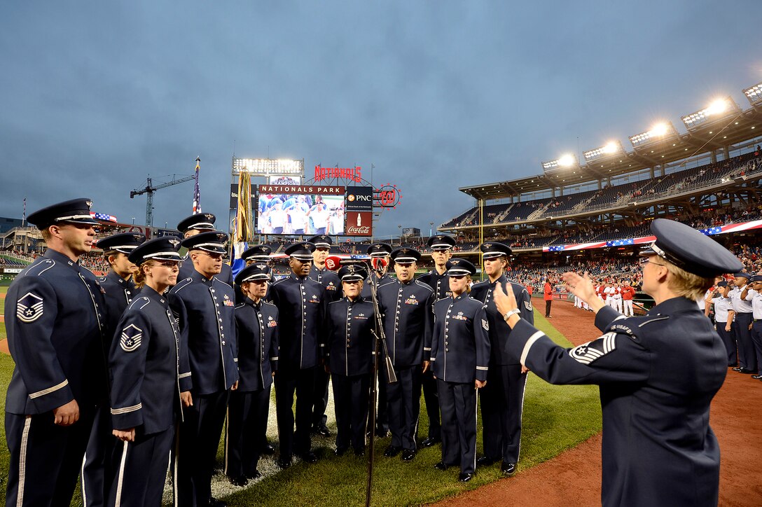 Members of the Air Force Band's Singing Sergeants perform the National Anthem at the Nationals' "Air Force Salute" at Nationals Park, Washington, D.C., Sept. 25, 2014.  The Nationals celebrated the Air Force birthday with Secretary of the Air Force Deborah Lee James throwing the first pitch and Air Force Chief of Staff Gen. Mark A. Welsh III delivering the first ball, and approximately 50 Airmen lined the field to open the game with the New York Mets.  (U.S. Air Force photo/Scott M. Ash)