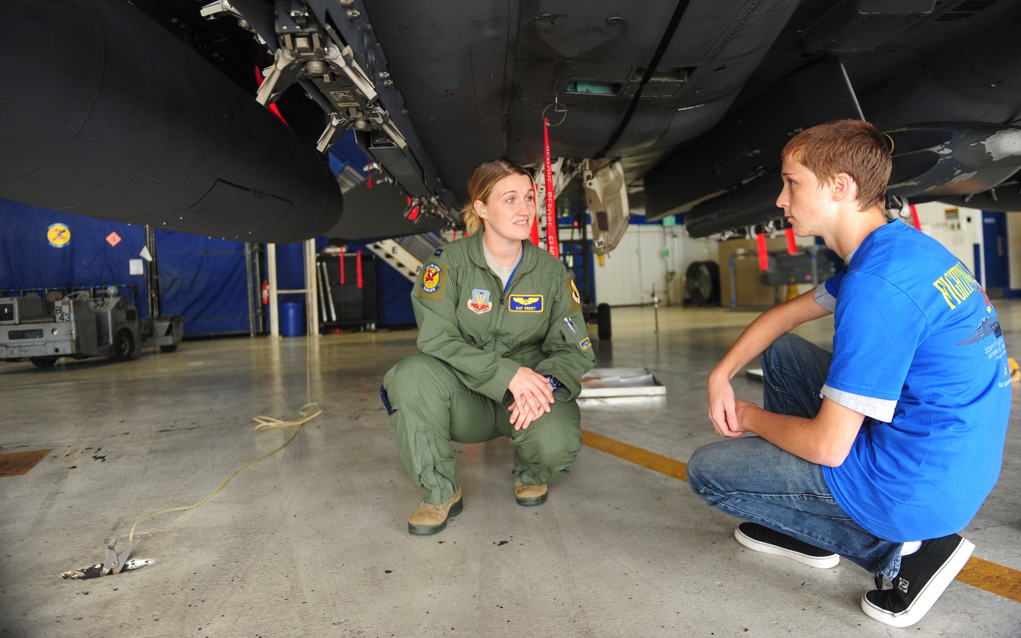 Capt. Kathleen Frost, 334th Fighter Squadron weapons systems officer instructor, shows Jonathan Dase the undercarriage of an F-15E Strike Eagle during his visit to Seymour Johnson Air Force Base, North Carolina, on Sept. 23, 2014. The 334th Fighter Squadron hosted Dase as part of their Pilot for a Day program. Dase suffers from a rare eye condition called keratoconus. (U.S. Air Force photo/Airman 1st Class Brittain Crolley)