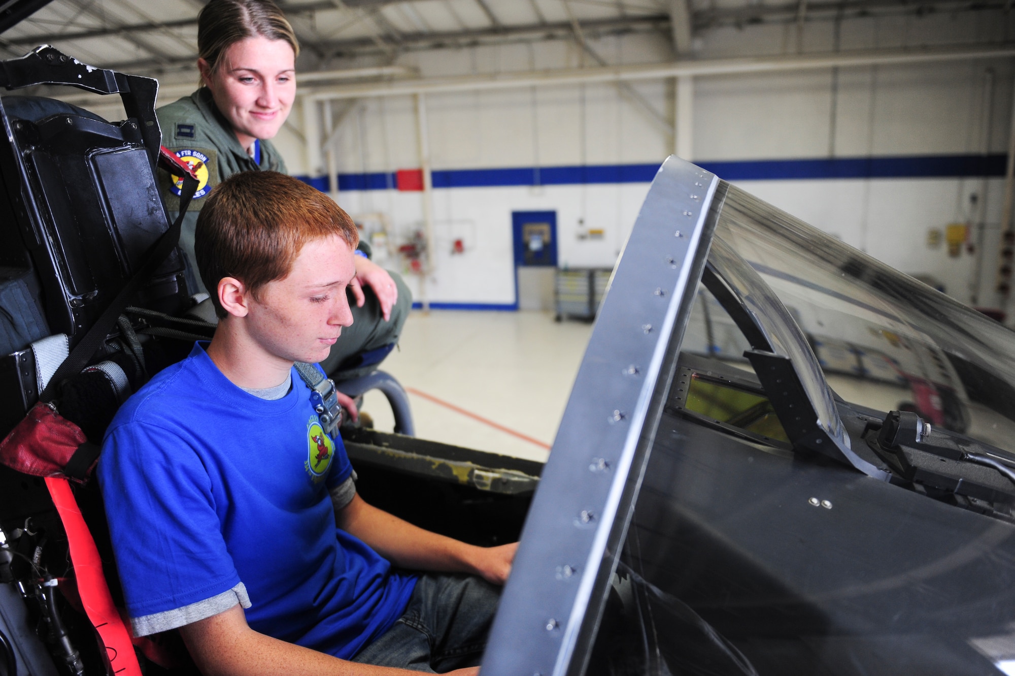 Capt. Kathleen Frost, 334th Fighter Squadron weapons systems officer instructor, shows Jonathan Dase the cockpit of an F-15E Strike Eagle aircraft during his visit to Seymour Johnson Air Force Base, North Carolina on Sept. 23, 2014. The 334th Fighter Squadron hosted Dase as part of their Pilot for a Day program. Dase suffers from a rare eye condition called keratoconus. (U.S. Air Force photo/Airman 1st Class Brittain Crolley)