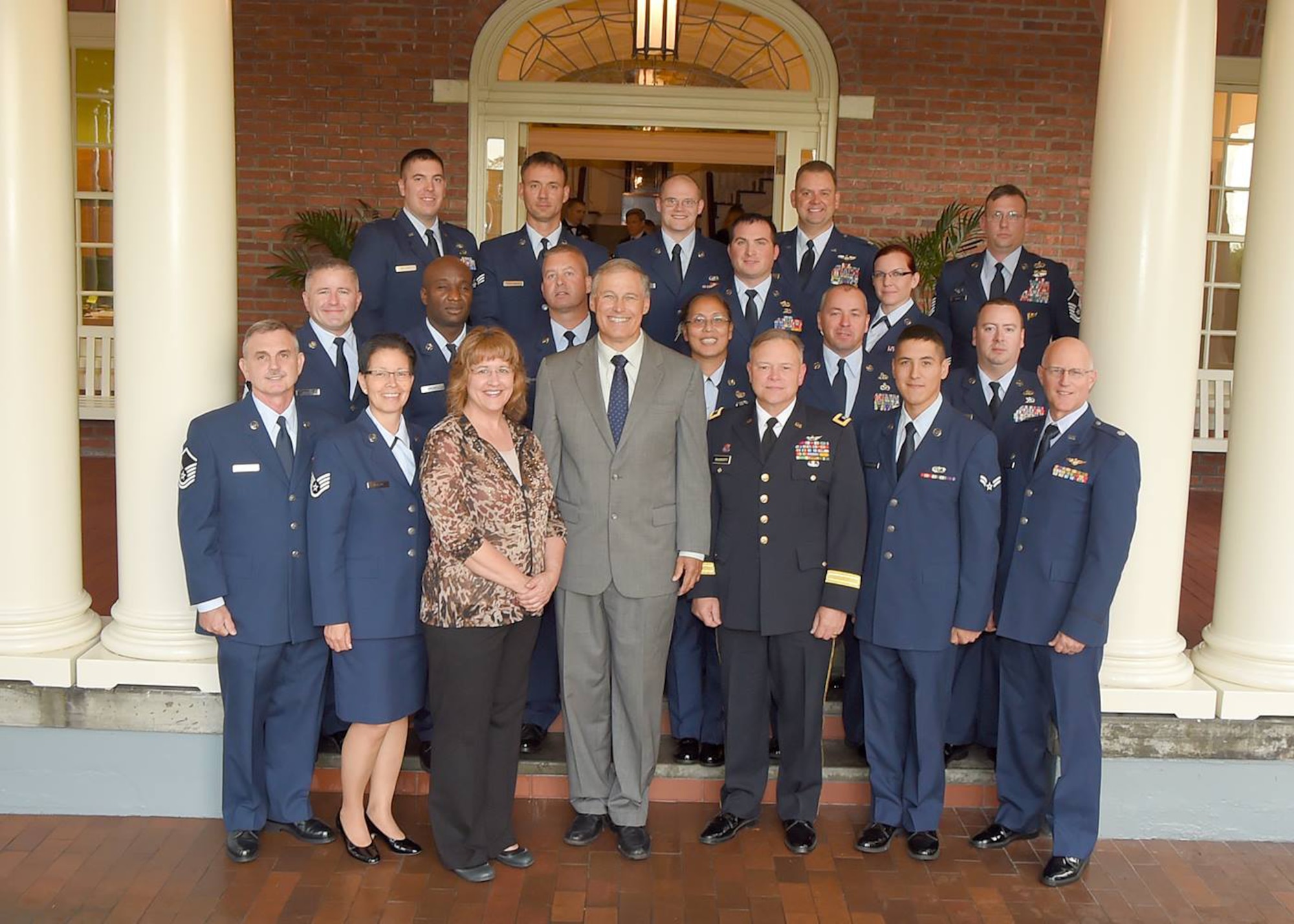 Washington State Gov. Jay Inslee, poses for a photograph with the Air National Guardsmen who assisted with the mud slide in Oso, Washington, at the governor’s mansion in Olympia, Washington, Sept. 29, 2014. The governor hosted a recognition ceremony for National Guardsmen and first responders to recognize their work on the Oso, Washington, slide. (U.S. Army photo/Capt. Joseph Siemandel)