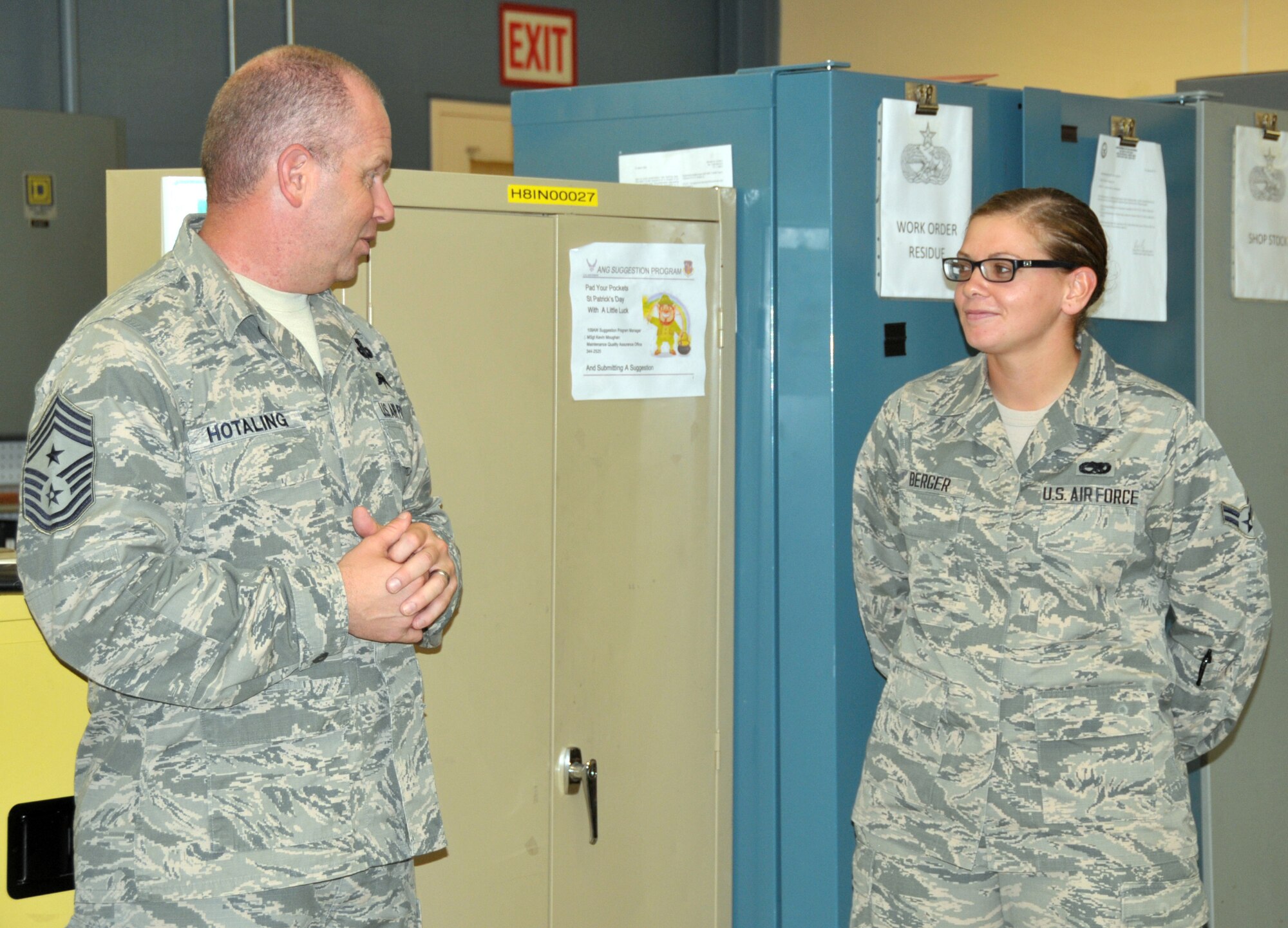Command Chief Master Sgt. of the Air National Guard James Hotaling coins Airman 1st Class Jennatte Berger of the 109th Maintenance Squadron during a visit to Stratton Air National Guard Base, New York, on Sept. 30, 2014. Berger was recognized by her leadership for being a stand out Airman. Hotaling visited Airmen throughout the base and also held an enlisted town hall meeting. He was at the base in preparation for an upcoming trip to Antarctica with the 109th Airlift Wing in support of Operation Deep Freeze. This will be his first trip to the ice. (U.S. Air National Guard photo by Tech. Sgt. Catharine Schmidt/Released)