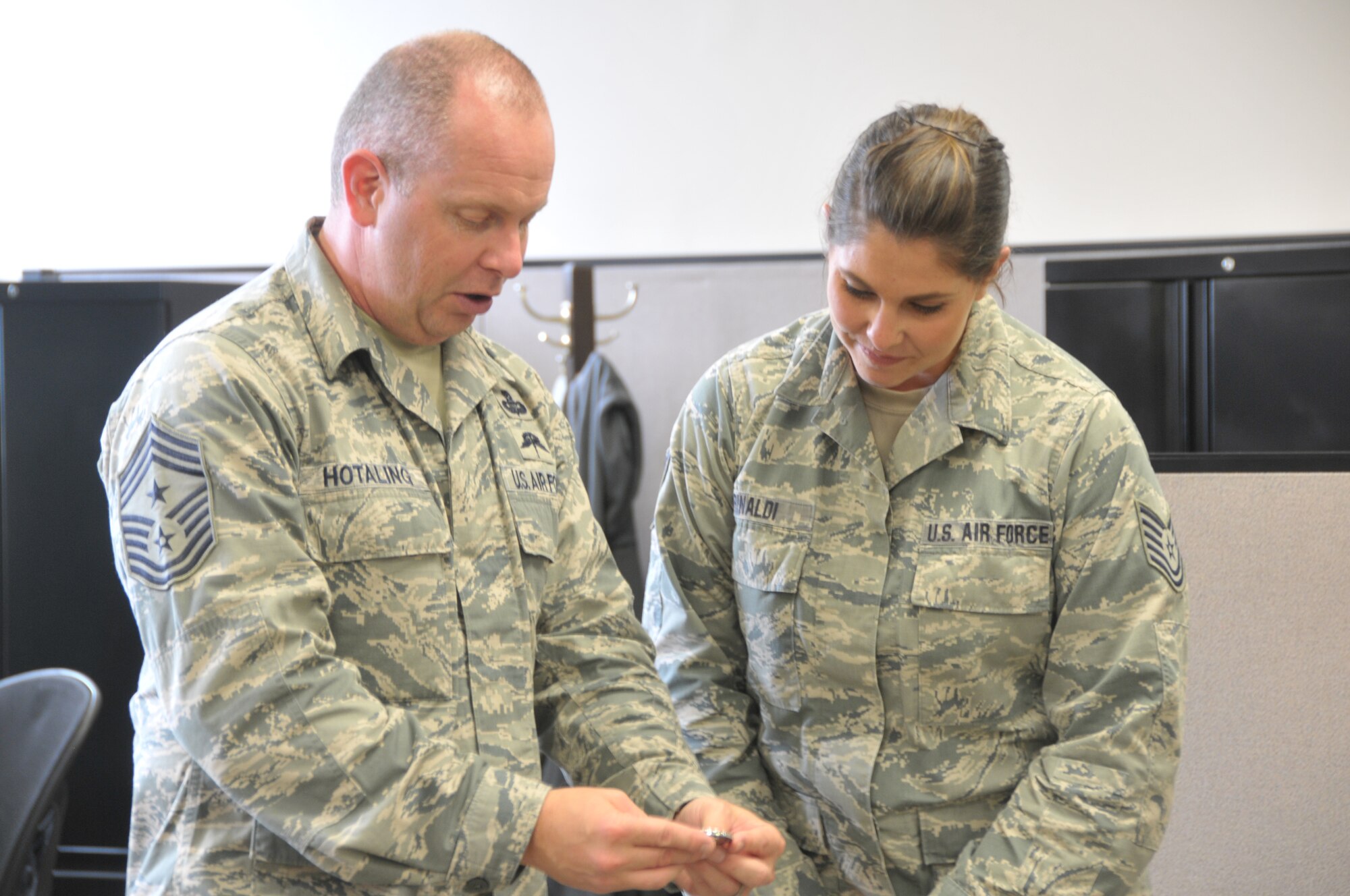 Command Chief Master Sgt. of the Air National Guard James Hotaling coins Tech. Sgt. Brittany Rinaldi of the 109th Force Support Squadron during a visit to Stratton Air National Guard Base, New York, on Sept. 30, 2014. Rinaldi was recognized by her leadership for being a stand out Airman. Hotaling visited Airmen throughout the base and also held an enlisted town hall meeting. He was at the base in preparation for an upcoming trip to Antarctica with the 109th Airlift Wing in support of Operation Deep Freeze. This will be his first trip to the ice. (U.S. Air National Guard photo by Tech. Sgt. Catharine Schmidt/Released)