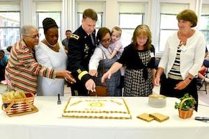 U.S. Army Brig. Gen. Christopher McPadden, U.S. Army Capability Requirements and Integration Command Concept Development and Learning Directorate director, cuts a cake with the mothers who attended the Gold Star Mother’s Day ceremony and candle-lighting at the Regimental Memorial Chapel at Fort Eustis, Va., Sept. 28, 2014. The Gold Star Mother’s Day is observed on the last Sunday of September every year. (U.S. Air Force photo by Airman 1st Class Kimberly Nagle/Released) 