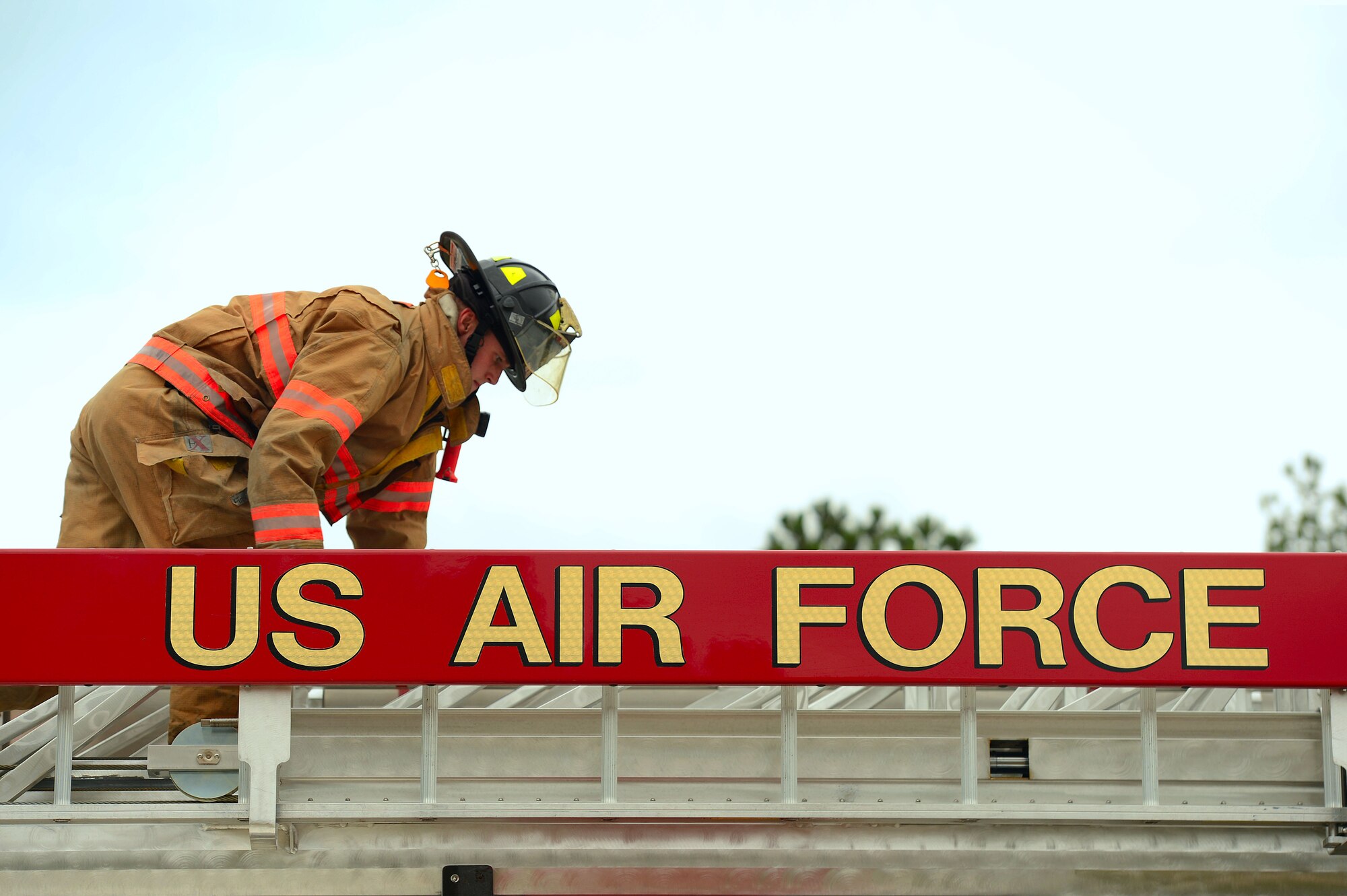 U.S. Air Force Senior Airman Adam Hunt, 20th Civil Engineer Squadron firefighter, performs an inspection on an aerial ladder during training at Shaw Air Force Base, S.C., Sept. 26, 2014. Hunt practiced putting the ladder in rescue mode, a method used to rescue people from a building, and firefighting mode, used to spray water from the top of the ladder. (U.S. Air Force photo by Airman 1st Class Jensen Stidham/Released) 