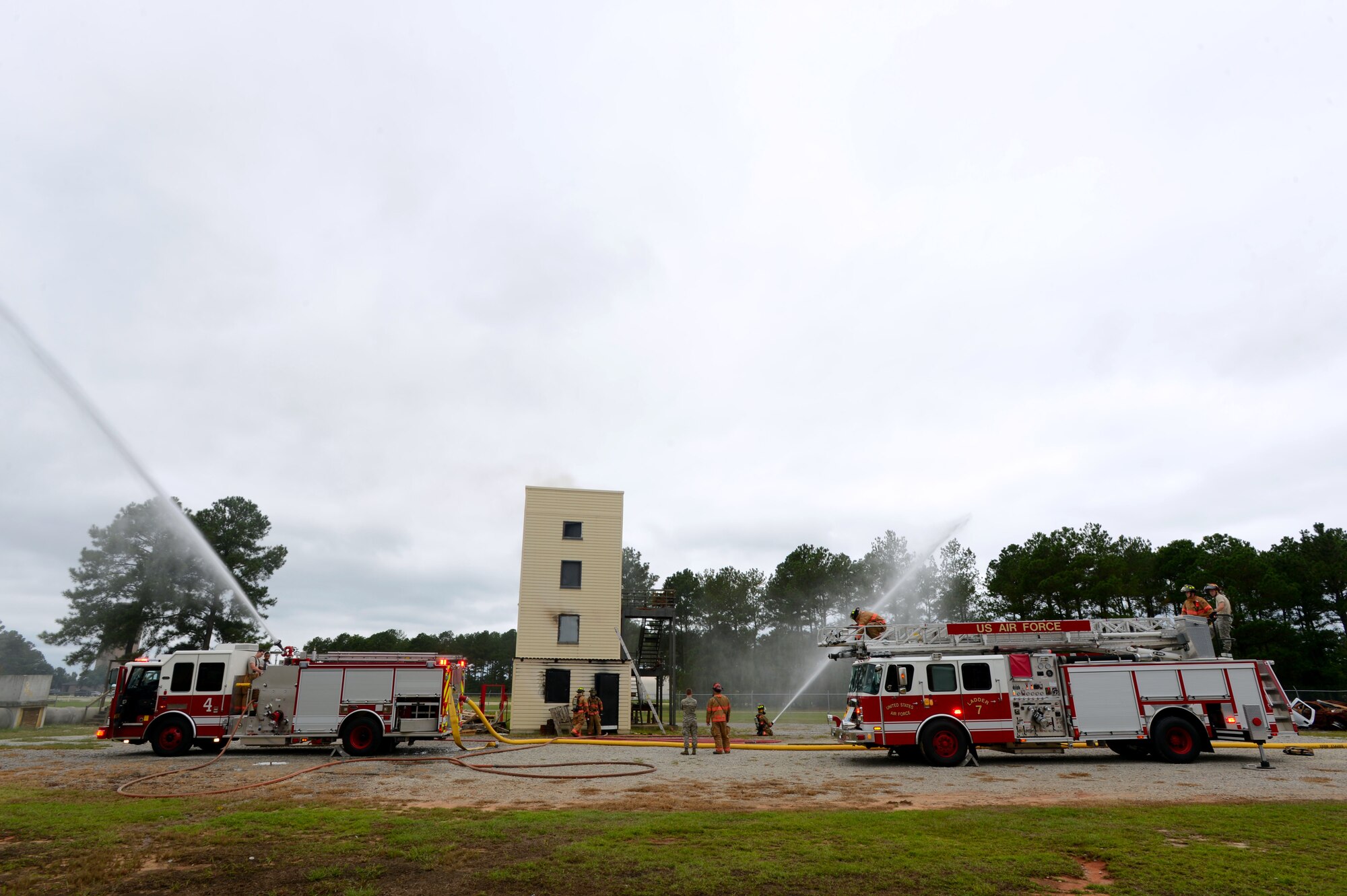 The 20th Civil Engineer Squadron Fire Department conducts a live fire structural burn at Shaw Air Force Base, S.C., Sept. 26, 2014. During the no-notice training session, approximately 12 20th CES firefighters practiced extinguishing fire during several live scenarios. (U.S. Air Force photo by Airman 1st Class Jensen Stidham/Released)