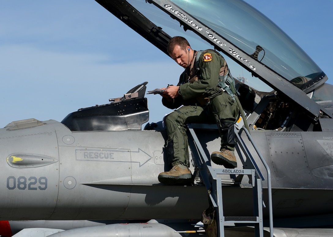 U.S. Air Force Maj. Bradley Sullivan, 480th Fighter Squadron pilot, conducts a pre-flight check before a take-off at Lask Air Base, Poland, June 11, 2014. Sullivan was an instructor pilot during his previous assignment at Joint Base San Antonio-Randolph, Texas. While participating in Polish-led exercise EAGLE TALON, he also flew with a former student from the Polish air force. (U.S. Air Force photo by Airman 1st Class Kyle Gese/Released) 