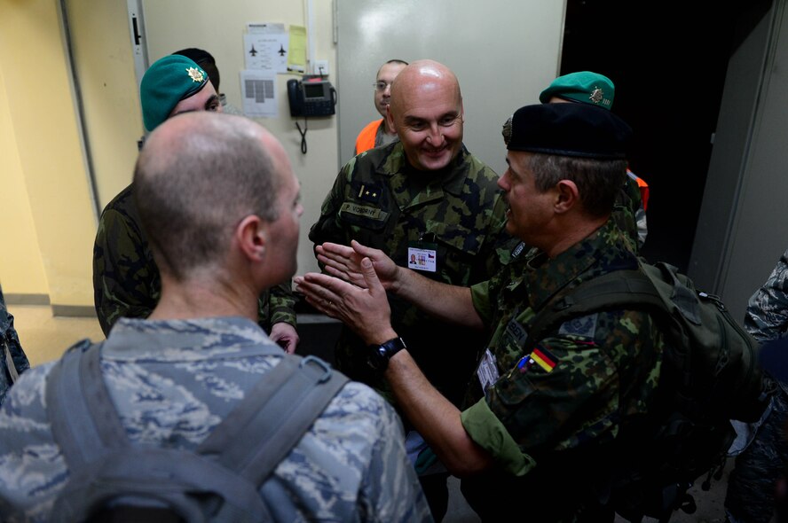 German Bundeswehr Lt. Col. Siegfried Houben, Host-Nation German Verification Agency escort, talks with other inspectors from the Czech Republic about gaining entrance to a facility during an exercise at Spangdahlem Air Base, Germany, Sept. 29, 2014. The Conventional Armed Forces in Europe treaty allows treaty signatories to inspect one another’s bases to determine compliance with treaty regulations. The CFE treaty limits the amount of warfighting equipment to an acceptable volume to eliminate unfair advantages of other nations. (U.S. Air Force photo by Airman 1st Class Kyle Gese/Released)