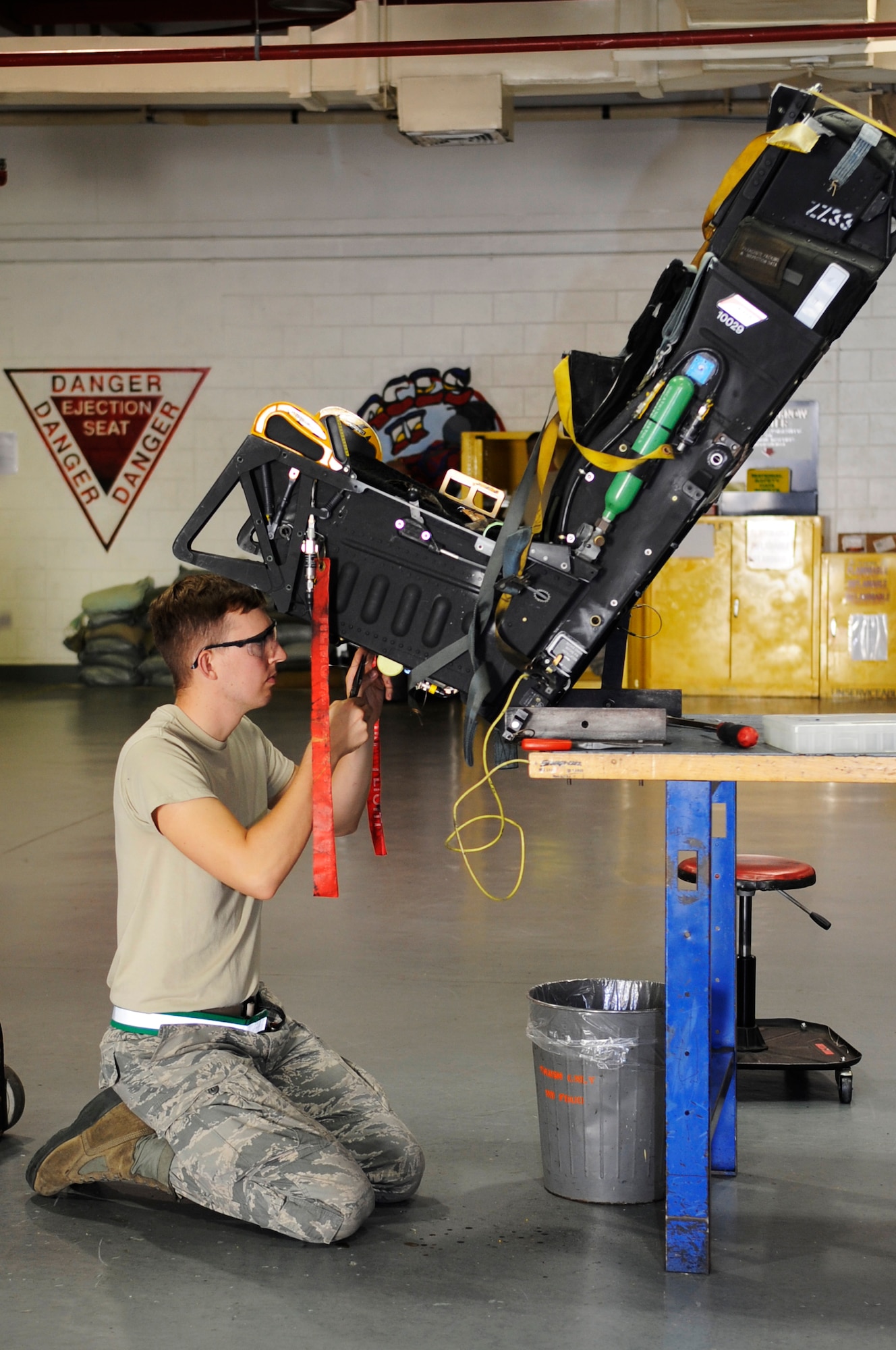 U.S. Air Force Airman 1st Class Stephen Krueger, 18th Component Maintenance Squadron egress systems apprentice, installs a gyro cartridge into an Advanced Concept Ejection Seat II on Kadena Air Base, Japan, Sept. 30, 2014. Egress is responsible for arming, de-arming, removing, inspecting and installing ACES II and its components that allow pilots to eject safely. (U.S. Air Force photo by Senior Airman Marcus Morris/Released)