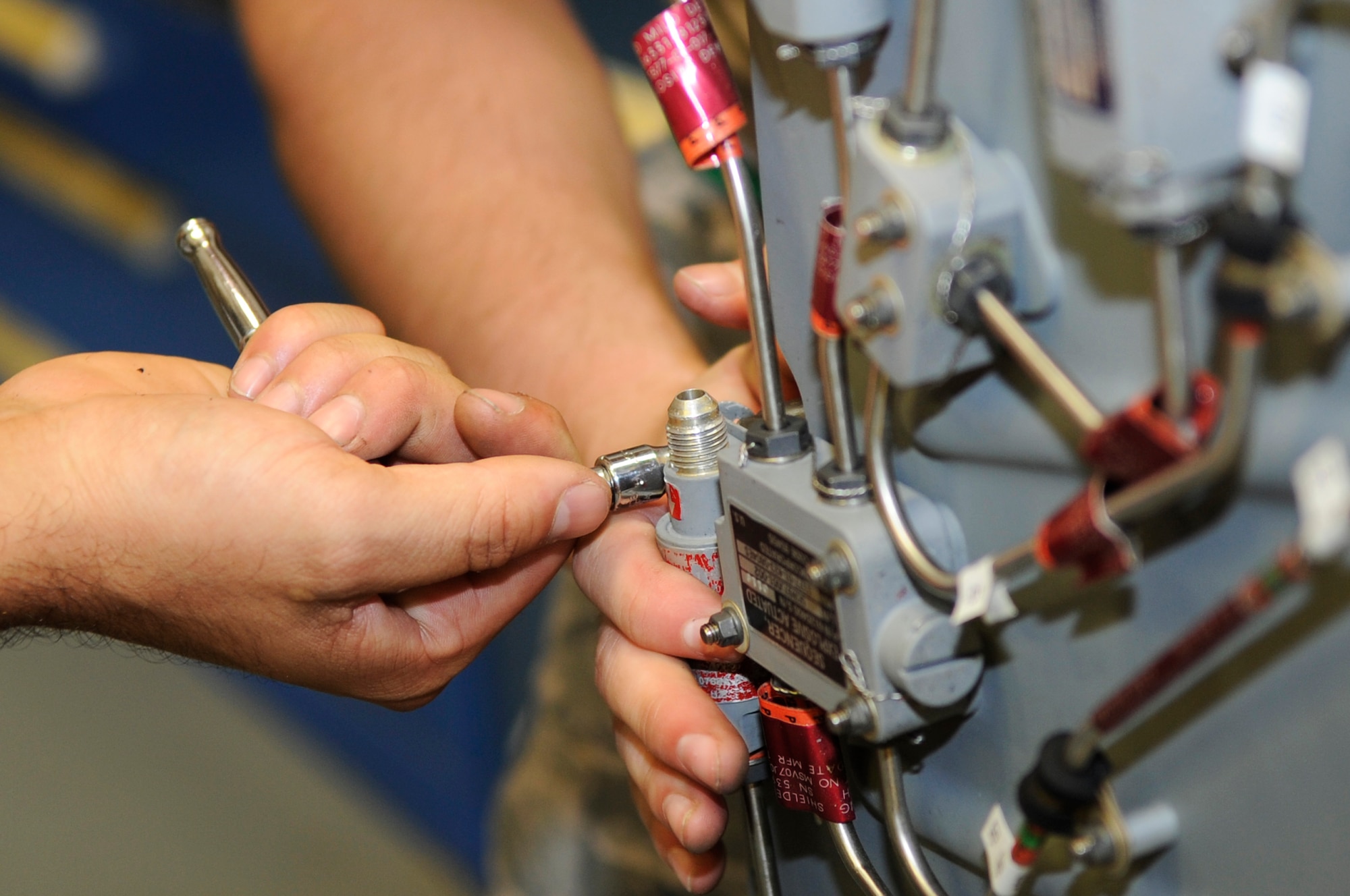An 18th Component Maintenance Squadron egress systems technician tightens down a bolt for the Advanced Concept Ejection Seat II on Kadena Air Base, Japan, Sept. 30, 2014. The technicians are responsible for arming, de-arming, removing, inspecting and installing ACES II and its components that allow pilots to eject safely. (U.S. Air Force photo by Senior Airman Marcus Morris/Released)