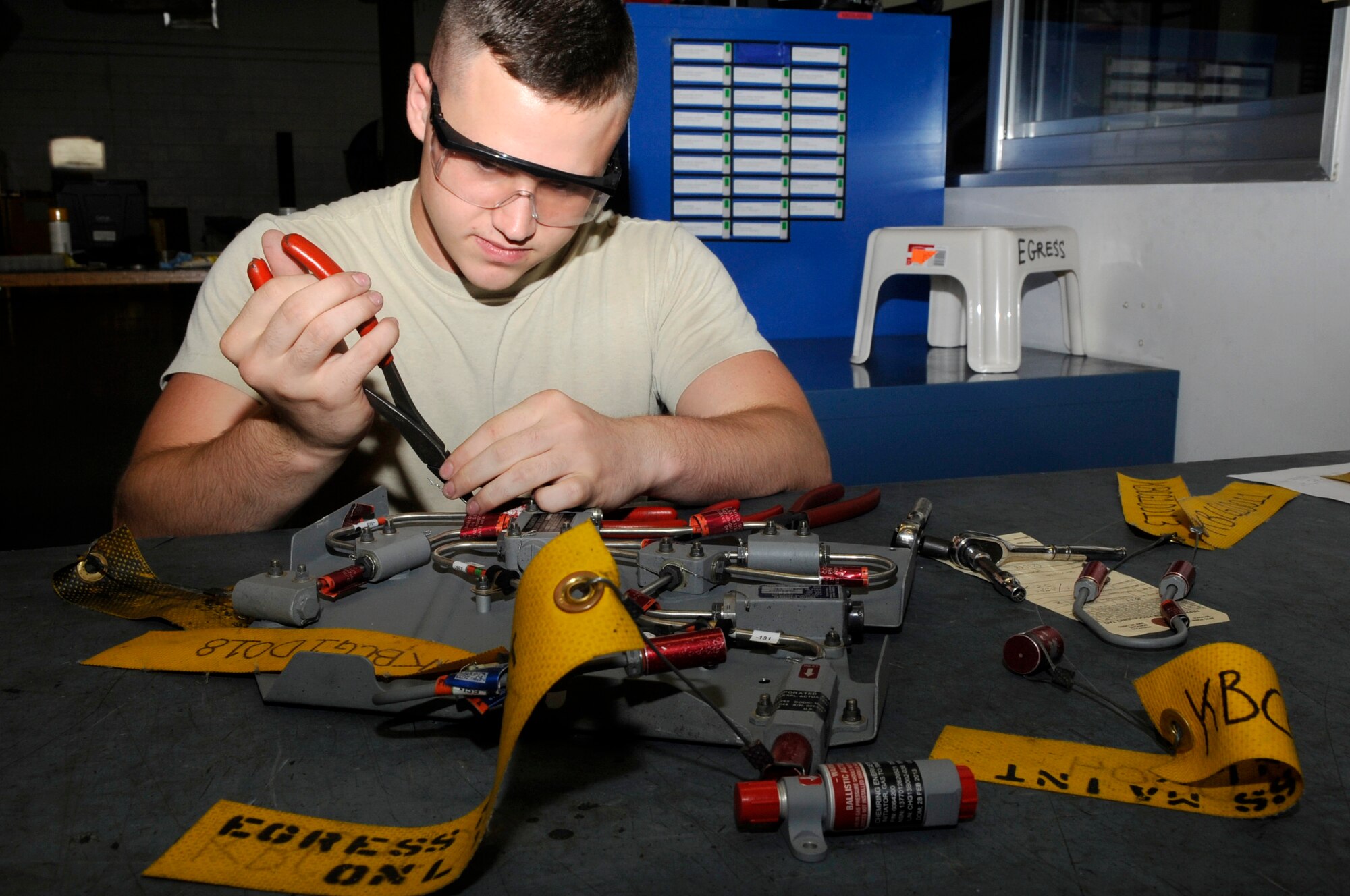 U.S. Air Force Airman 1st Class Taylor Bowers 18th Component Maintenance Squadron egress systems apprentice, replaces a gas shielded mild detonator cord from an F-15 Eagle on Kadena Air Base, Japan, Sept. 30, 2014. The detonator is part of the Advanced Concept Ejection Seat II and allows pilots to evacuate their aircraft safely in air. (U.S. Air Force photo by Senior Airman Marcus Morris/Released)