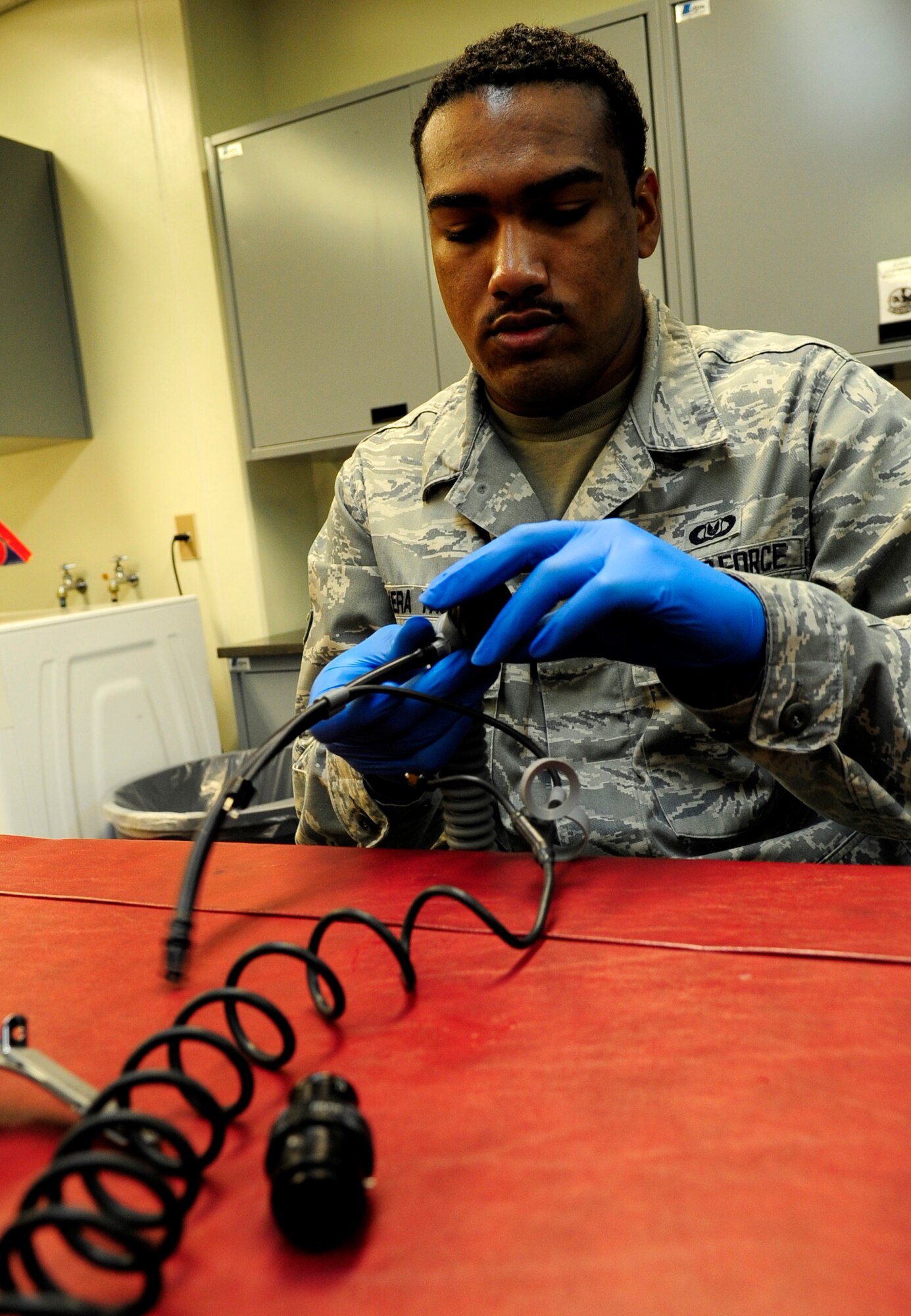 Airman 1st Class Antonio Rivera-Thomas, 18th Operations Support Squadron aircrew flight equipment apprentice, reassembles a mask breathing unit for a joint helmeted mounted cueing system on Kadena Air Base, Japan, Sept. 30, 2014. Working on more than 15 aircrew members equipment per week, members of the 18th OSS aircrew equipment shop maintain helmets, joint helmeted mounted cueing systems, harness', survival vests, advance technology anti-gravity systems, gravity suits, night vision goggles and chemical gear.(U.S. Air Force photo by Airman 1st Class Keith James/Released)