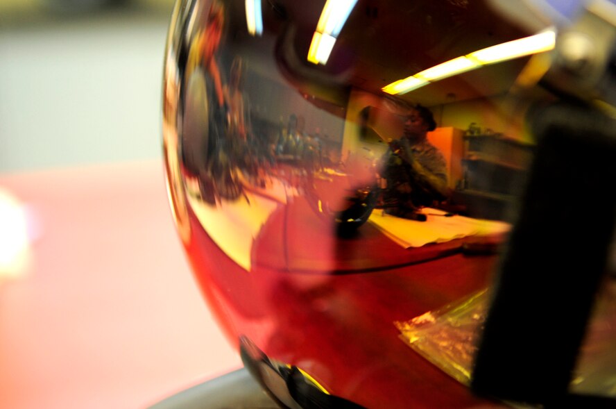 Senior Airman Christina Leonard, 18th Operations Support Squadron aircrew flight equipment journeymen, works on a pilot's helmet on Kadena Air Base, Japan, Sept. 30, 2014. The mission of the 18th OSS aircrew flight is to maintain all life saving equipment for all aircrew assigned to the 18th Wing.  (U.S. Air Force photo by Airman 1st Class Keith James/Released)