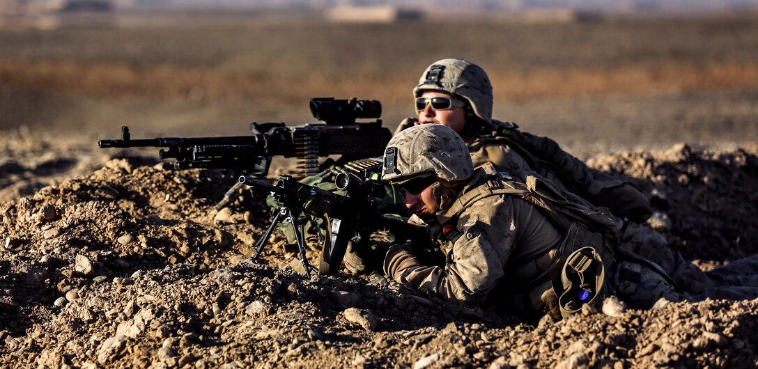 U.S. Marine Corps Lance Cpl. Maxim Lyman, foreground, and U.S. Marine Corps Cpl. Kevin Johnson provide overwatch during a security patrol in Washir district in Helmand province, Afghanistan, Sept. 29, 2014. Lyman, a gunner, and Johnson, a machine gunner, are assigned to Bravo Company, 1st Battalion, 2nd Marine Regiment.