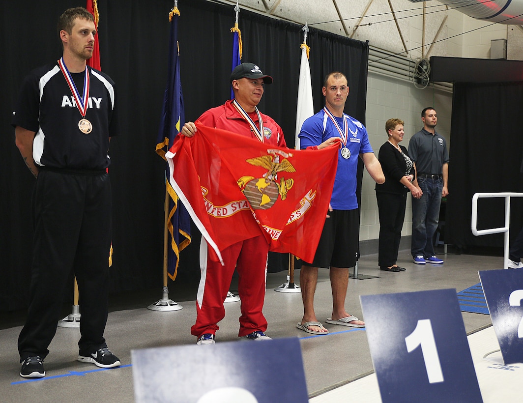 Marine Corps Gunnery Sgt. P. Ernesto Aquino receives the gold medal for winning the 50-meter freestyle swim during the Warrior Games at the U.S. Olympic Training Center in Colorado Springs, Colo., Sept. 30, 2014.