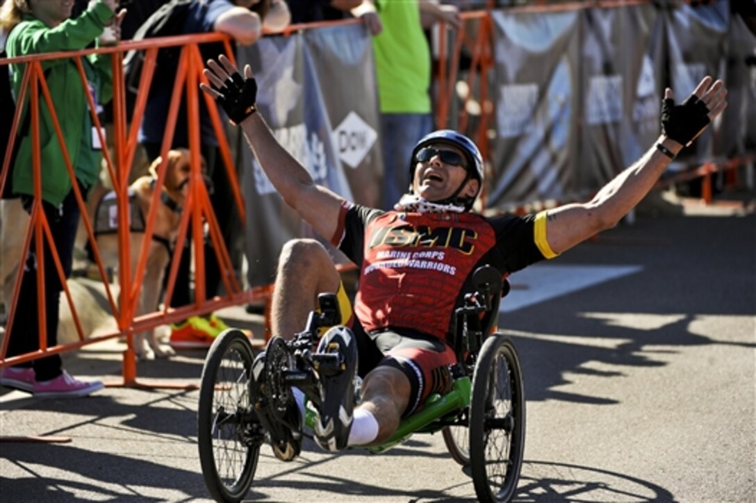 Marine Corps Staff Sgt. Adam Vickery of the Marine team reacts to winning the recumbent cycle race during the 2014 Warrior Games on Fort Carson, Colo., Sept. 29, 2014.