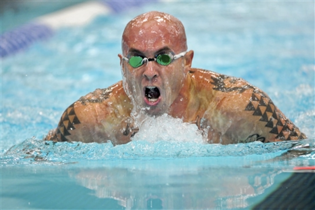 Navy Petty Officer 1st Class Jamie Sclater swims to gold in his division of the 50-meter breaststroke during the 2014 Warrior Games at the Olympic Training Center in Colorado Springs, Colo., Sept. 30, 2014. Sclater, a hospitalman, is competing on the Marine team.