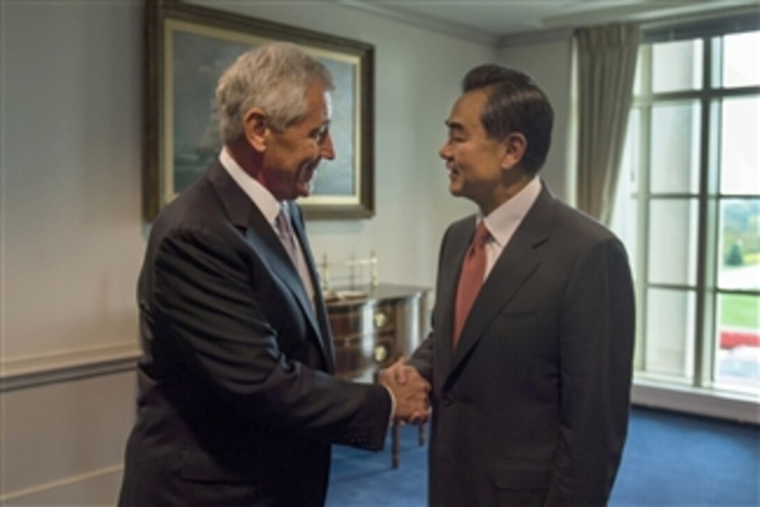 U.S. Defense Secretary Chuck Hagel, left, welcomes Chinese Foreign Minister Wang Yi to the Pentagon,  Oct. 1, 2014. The two leaders met to discuss issues of mutual importance.