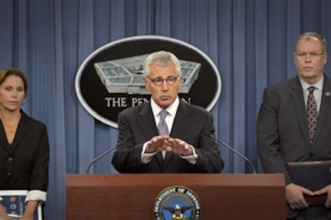 Defense Secretary Chuck Hagel and Deputy Defense Secretary Bob Work, right, discuss the Military Health System during a briefing for reporters at the Pentagon, Oct. 1, 2014. 