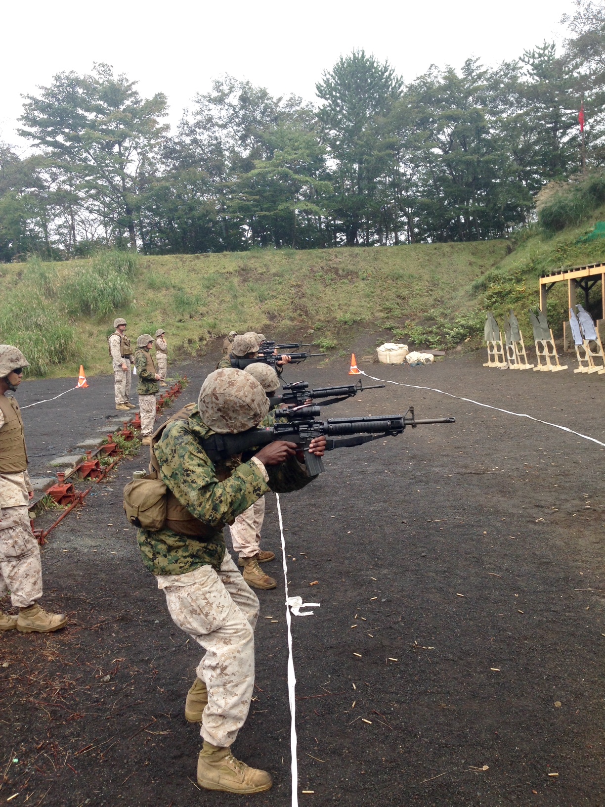 Marine and Sailors of Headquarters and Support Company, Camp Fuji, Japan conduct the Table 4 course of fire with their M16A4s. The purpose of the range was to certify Marines on their individual weapon systems and maintain currency in basic military skills.