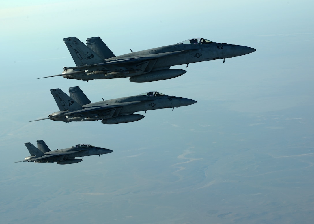 A formation of U.S. Navy F-18E Super Hornets leaves after receiving fuel from a KC-135 Stratotanker over northern Iraq, Sept. 23, 2014. These aircraft were part of a large coalition strike package that was the first to strike ISIL targets in Syria. (U.S. Air Force photo by Staff Sgt. Shawn Nickel)